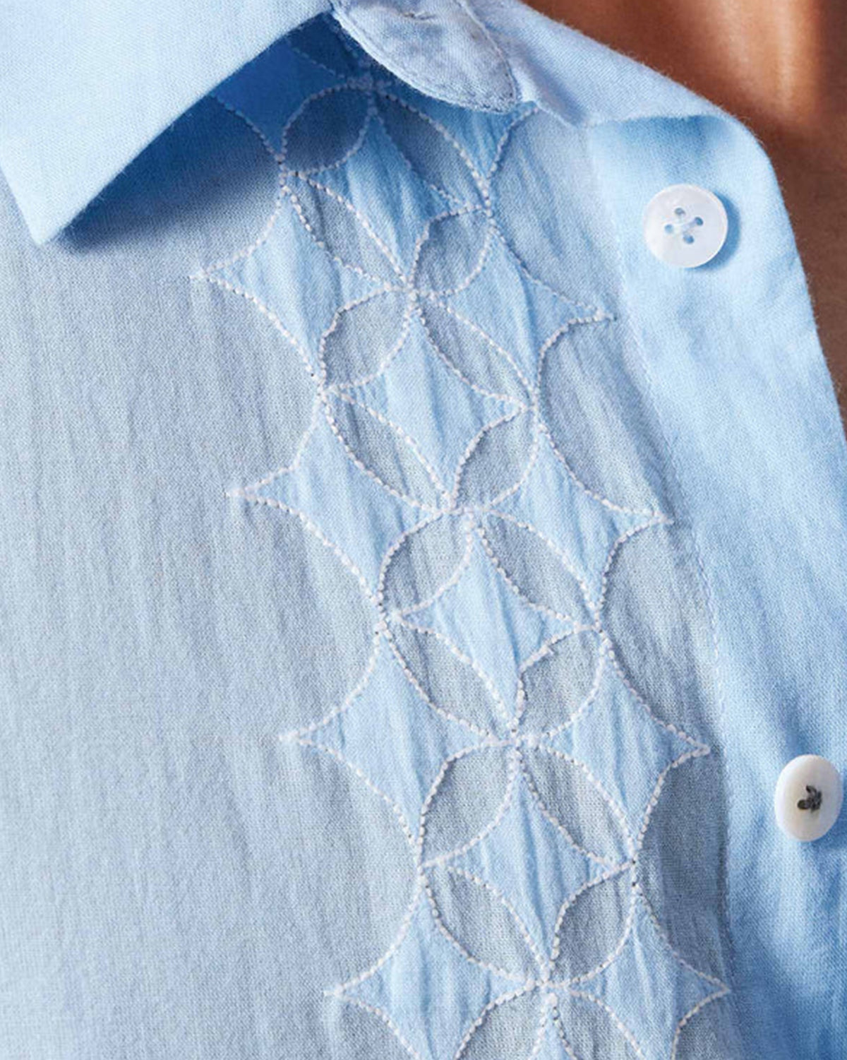 Close-up of a light blue Half Sleeve Shirt showing white geometric embroidery.