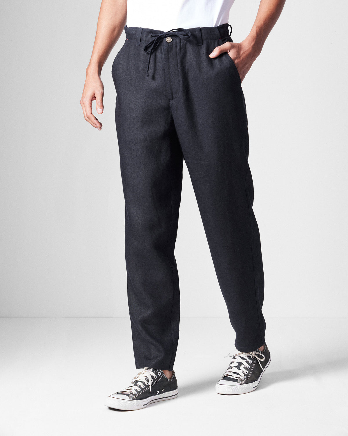 Person wearing black Karo Pants with a drawstring waist.