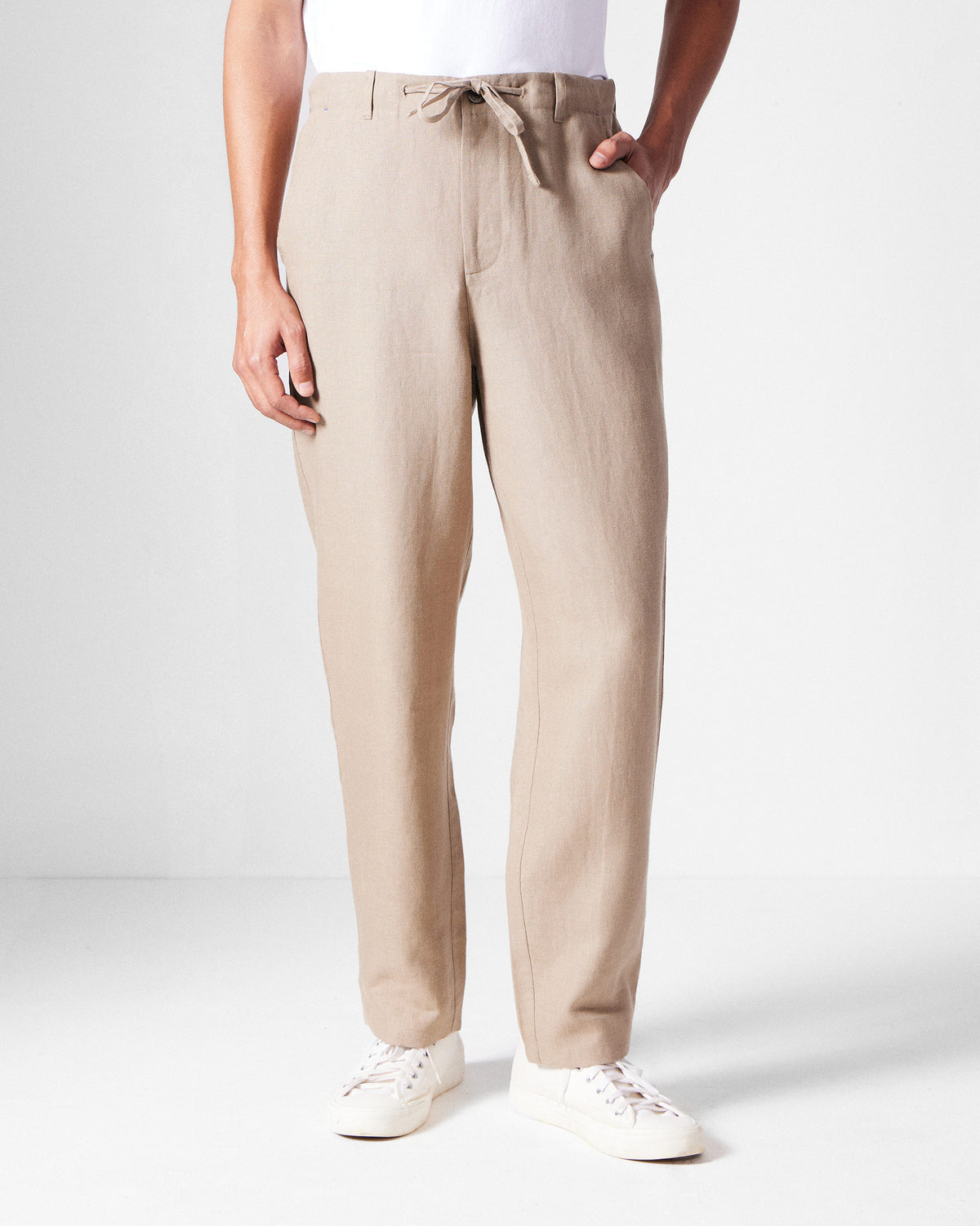Person wearing light brown Karo Pants with a drawstring waist.