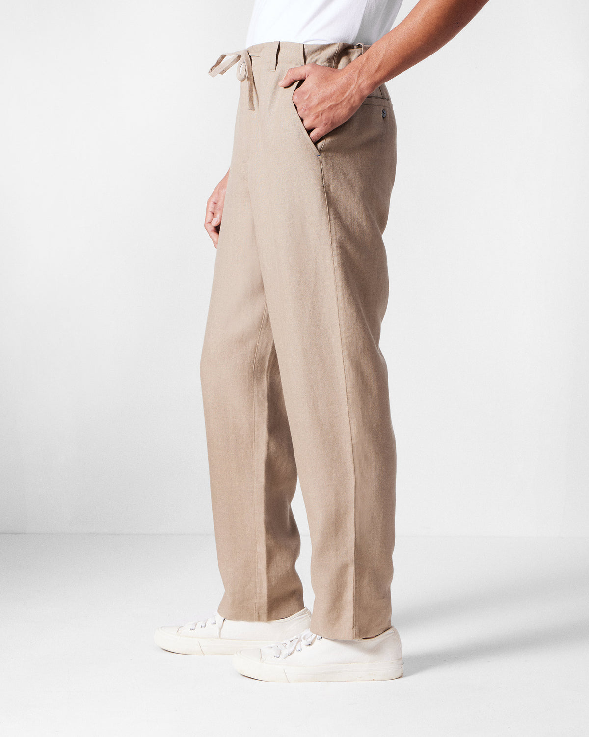 Side view of light brown Karo Pants showing the straight-leg drape.