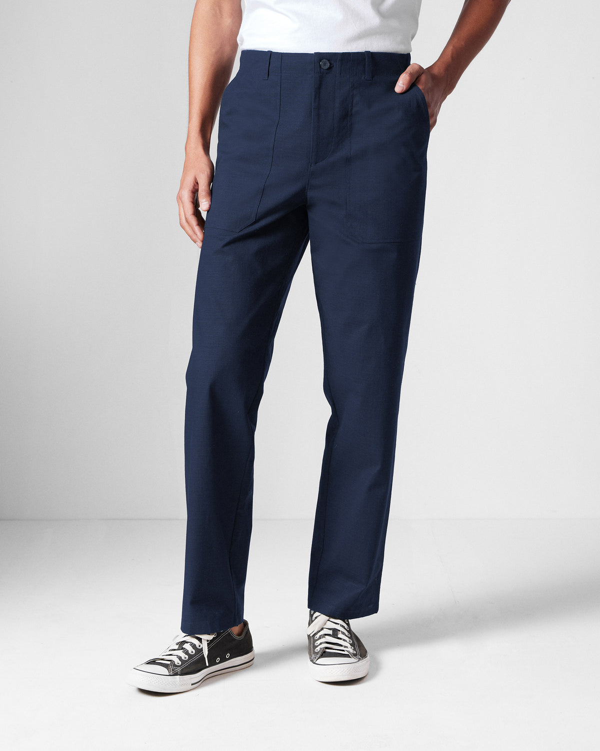 Person wearing navy Zar Pants with a button front.