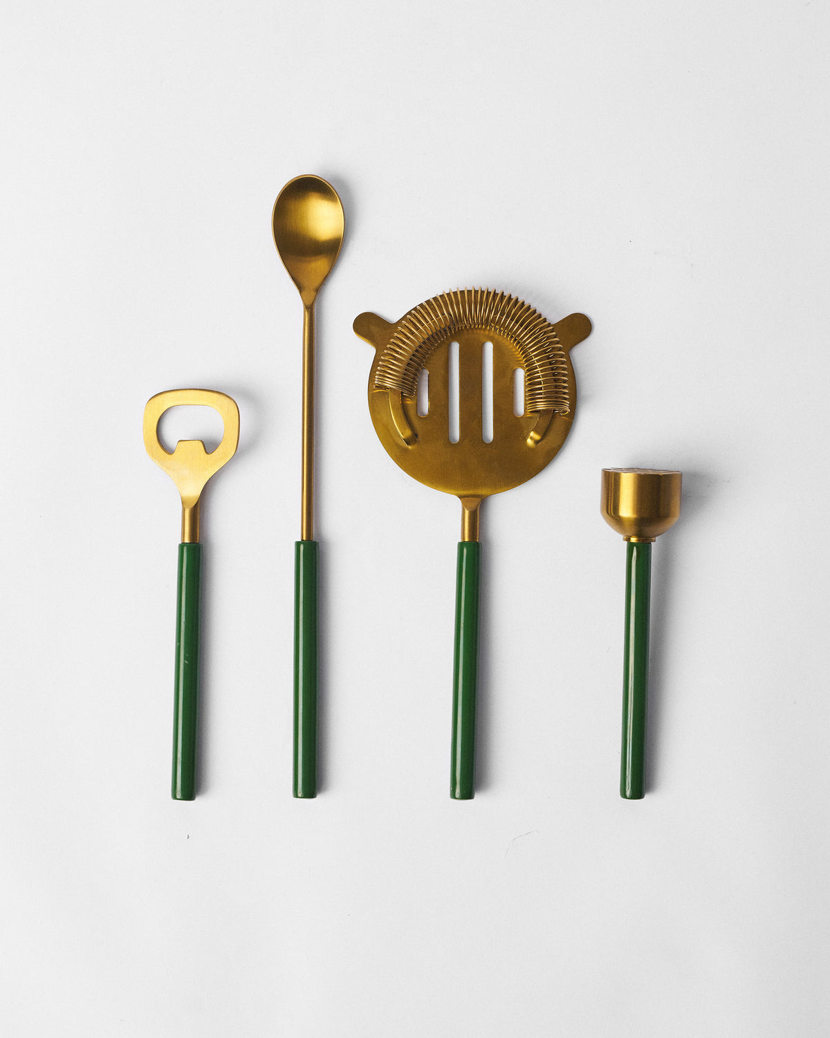 Four Bash bar tools with gold heads and forest green handles lined up together.