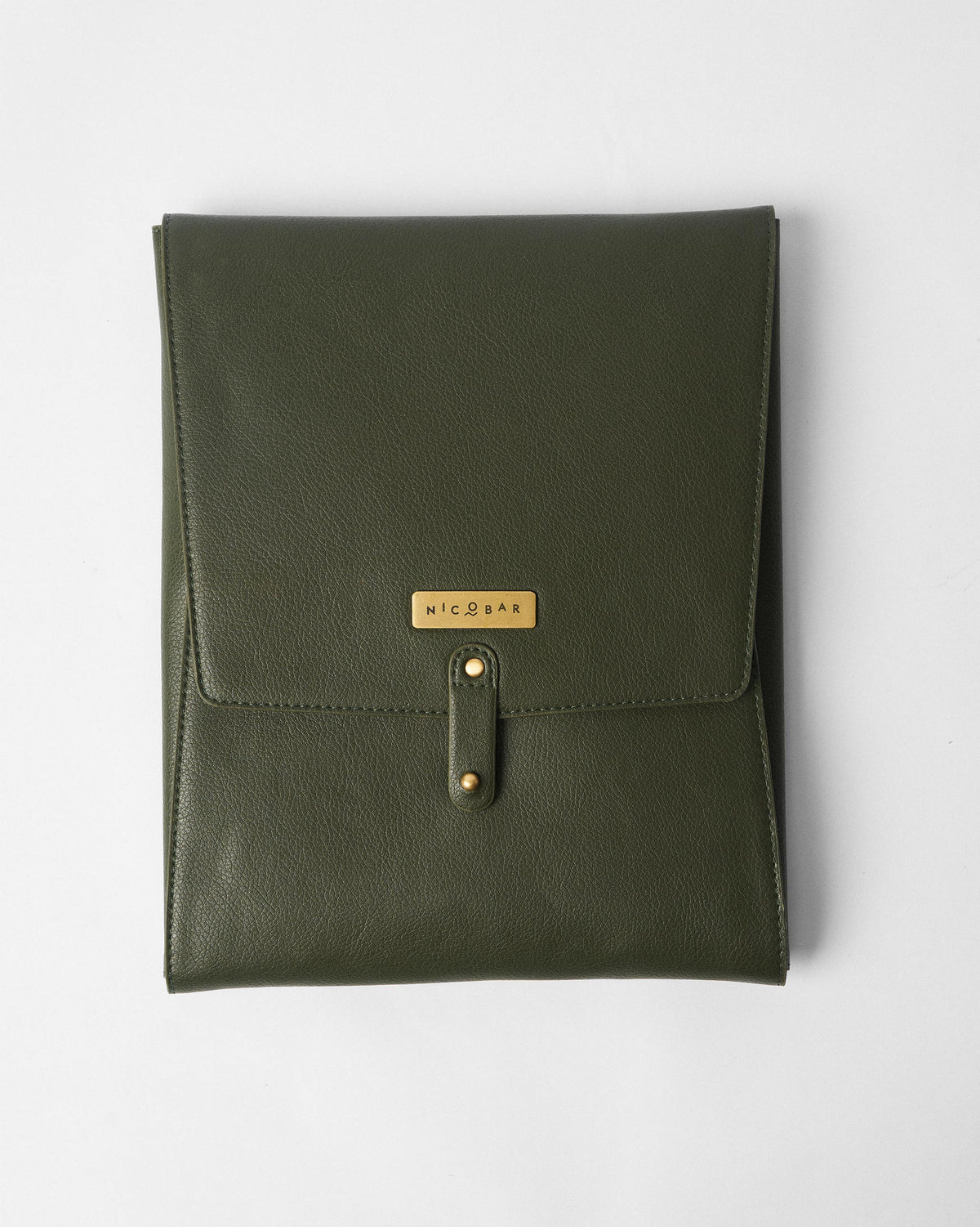 Closed olive pebbled Bash bar tools pouch with a brass Nicobar nameplate.