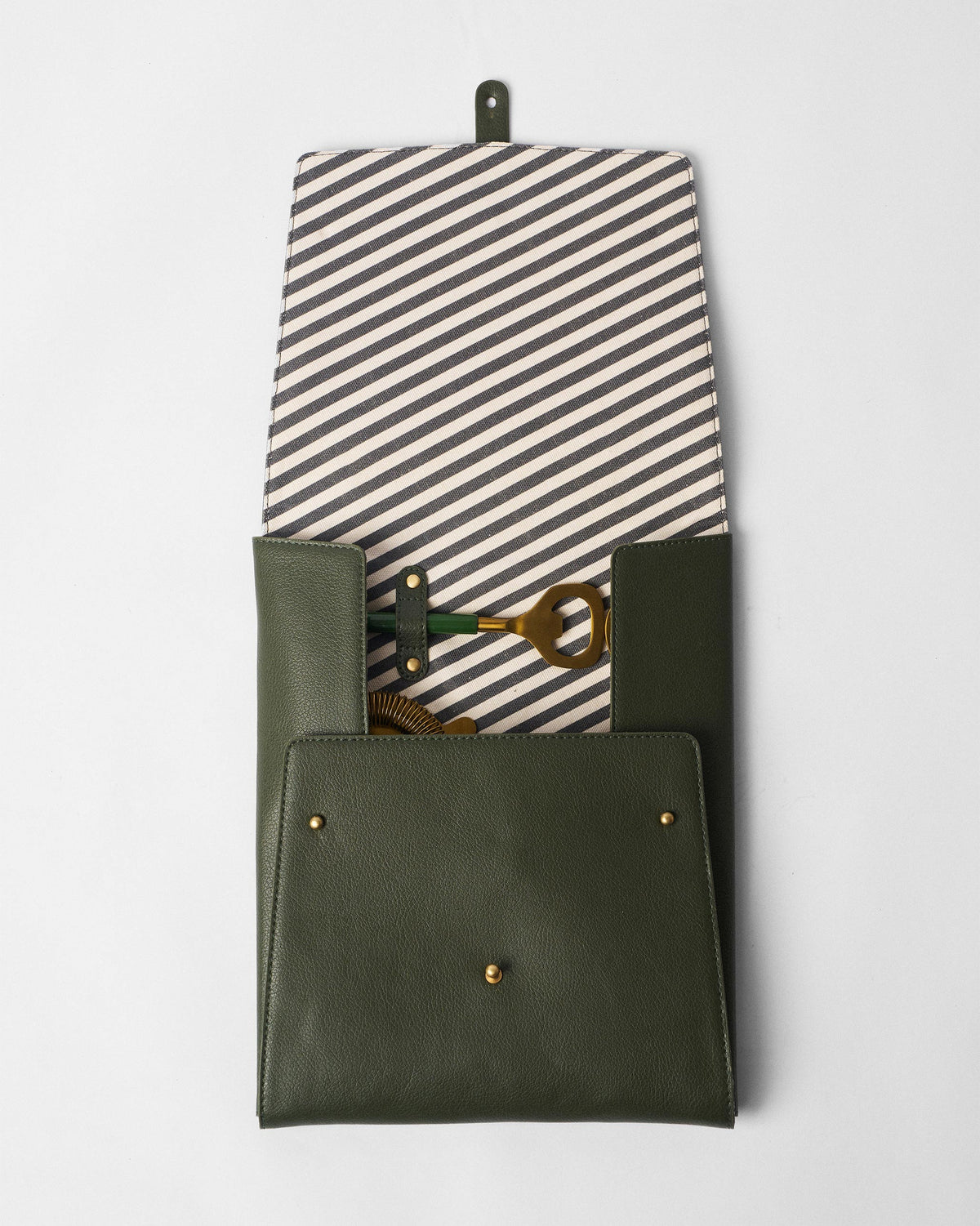 Open Bash bar tools pouch with striped lining and gold tools strapped inside.