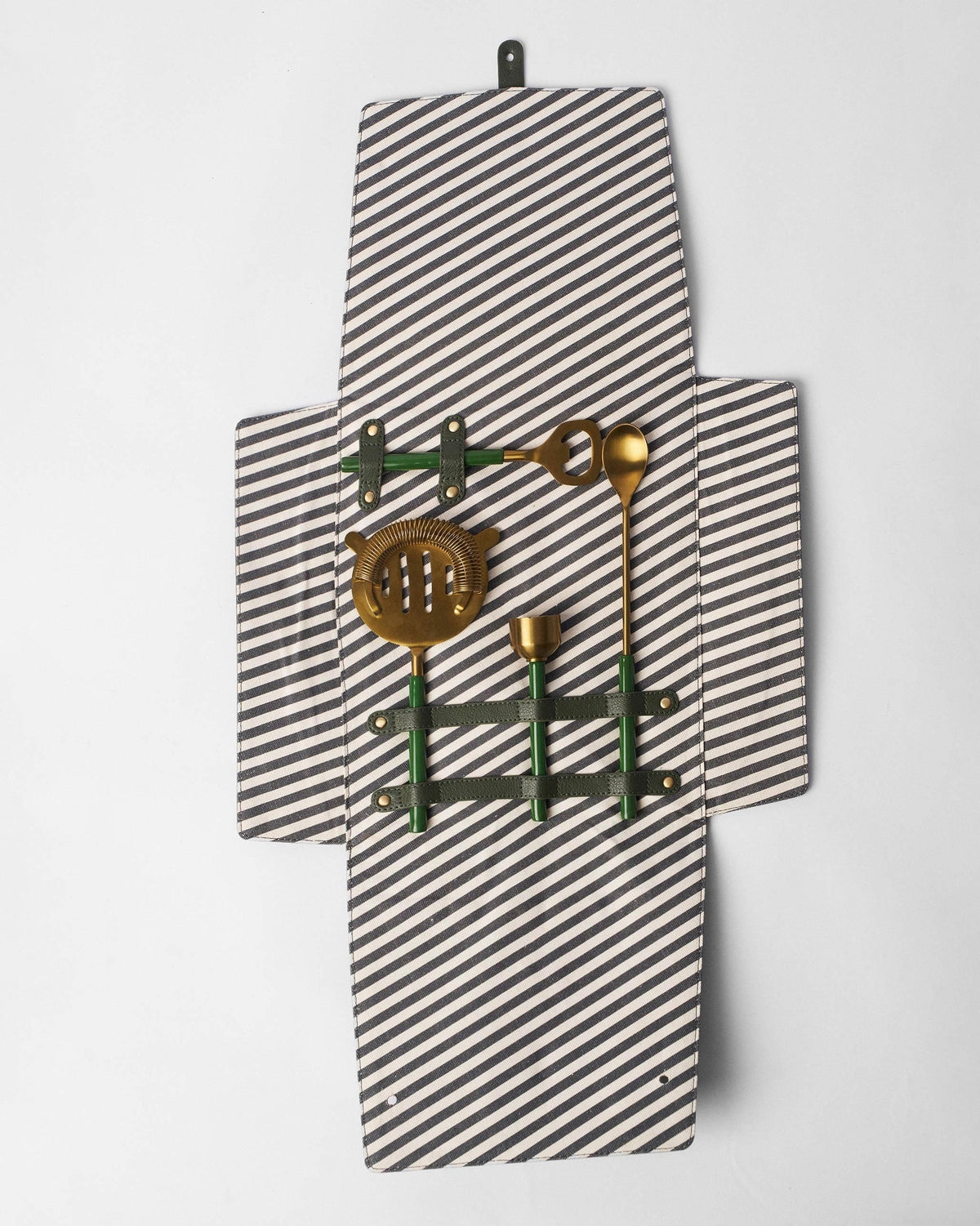 Striped Bash bar tools roll opened flat with four gold tools in leather straps.
