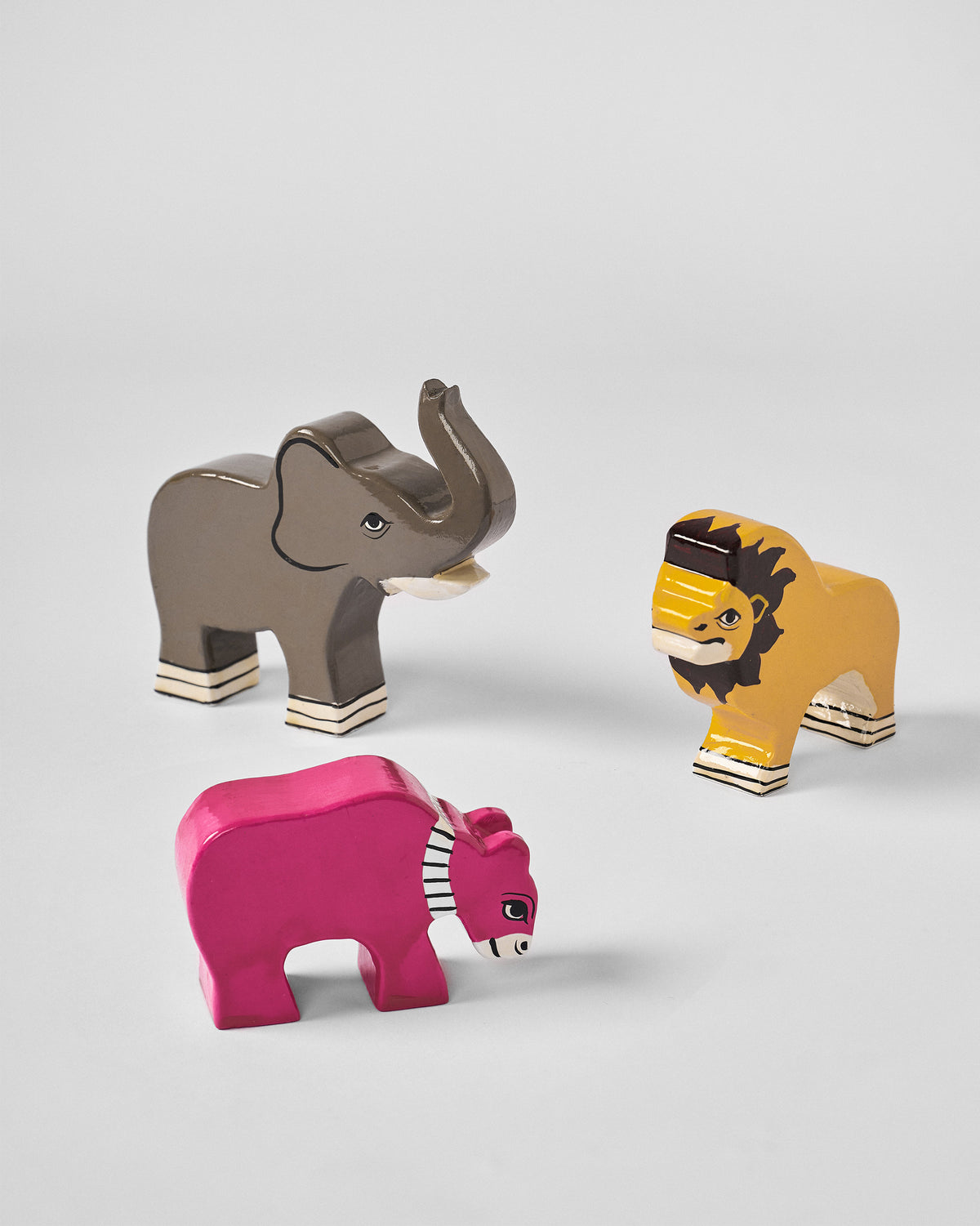 Nicojungle elephant, lion and pink figure grouped together.