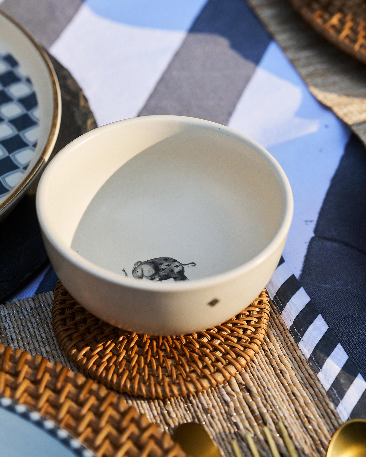 Haathi Katori with an elephant motif inside, placed on a wicker coaster.