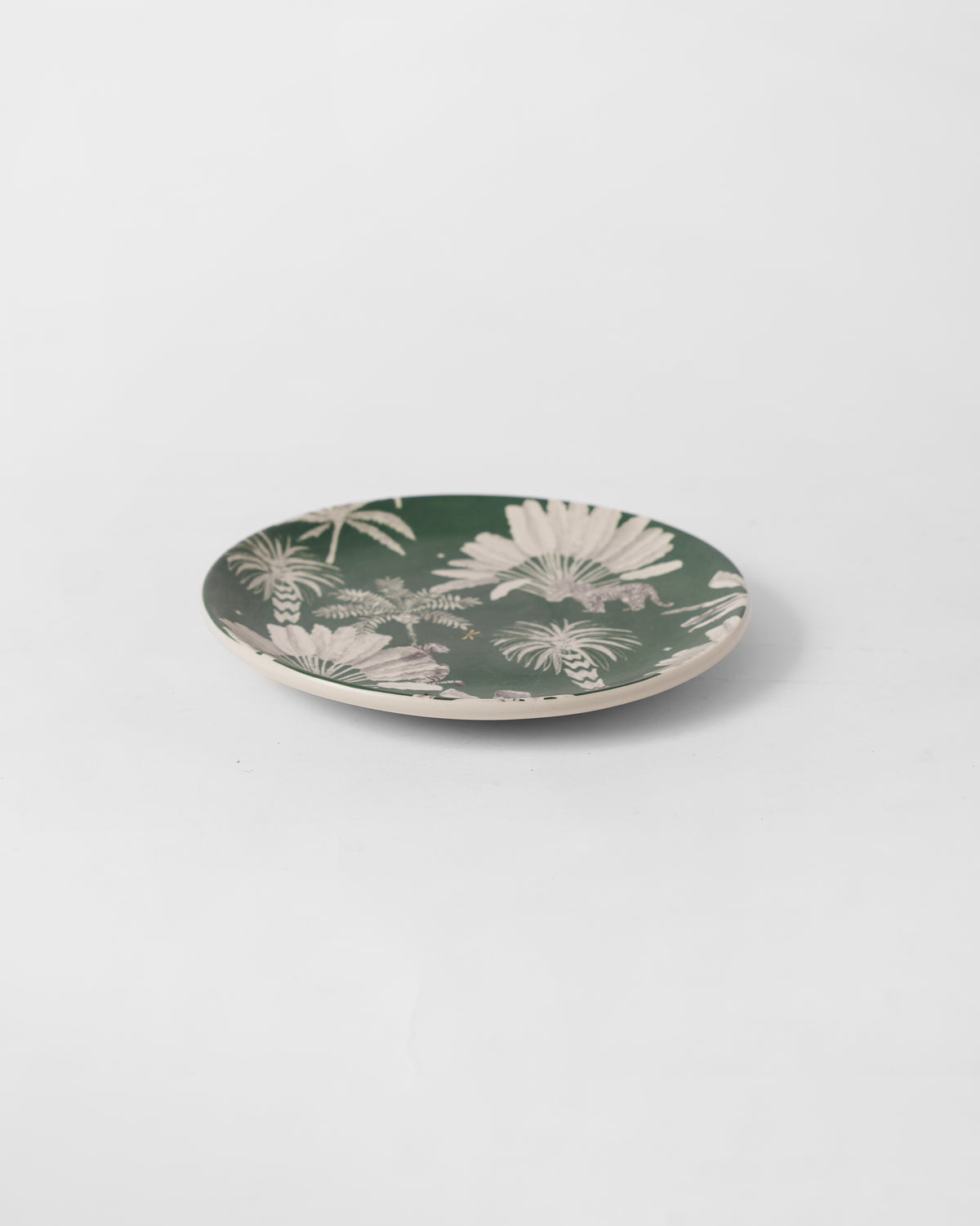 Haathi Quarter Plate in green with cream palm leaves and a spotted animal.