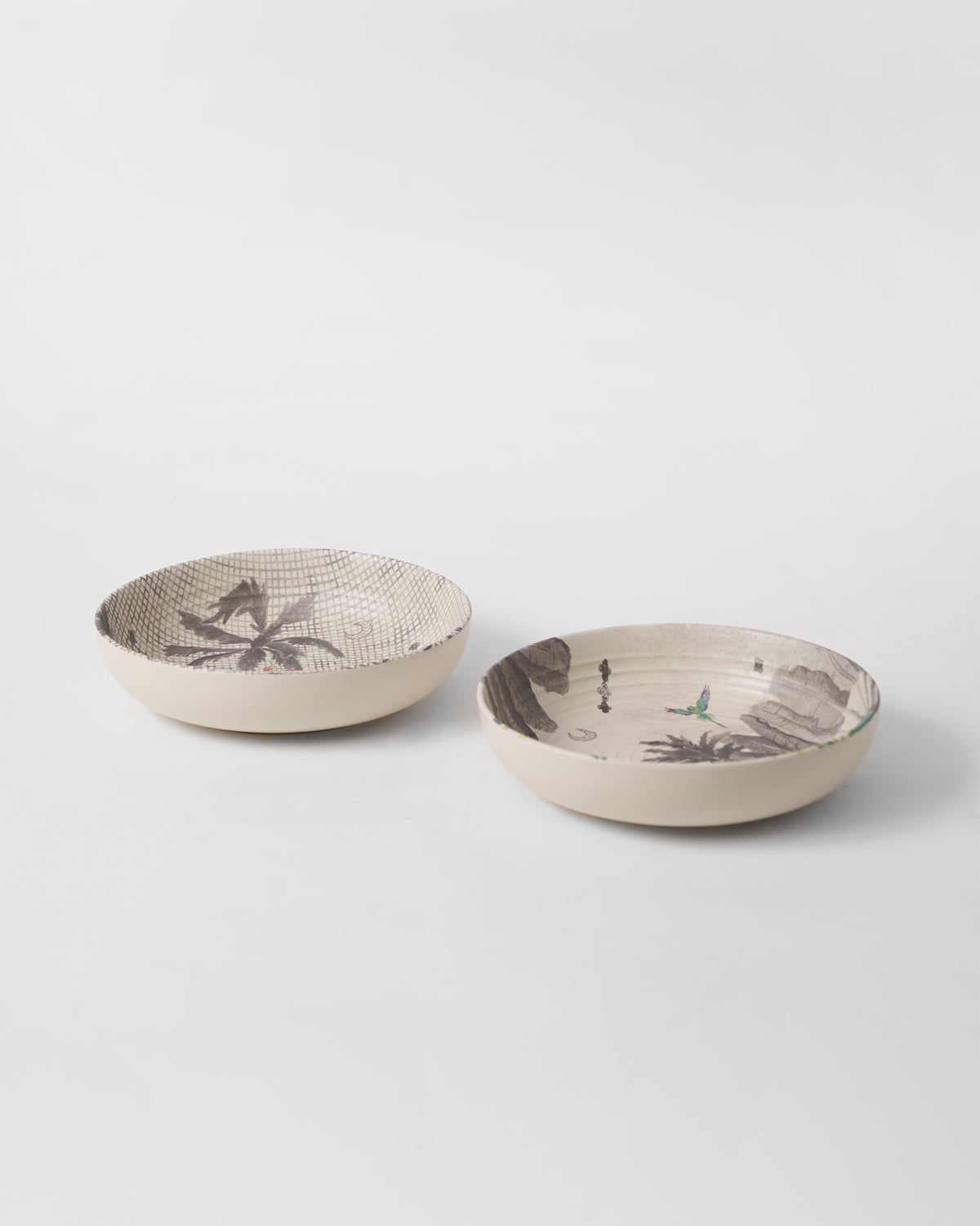 Pair of Haathi shallow bowls showing palm motifs, a grid print, and a small bird.