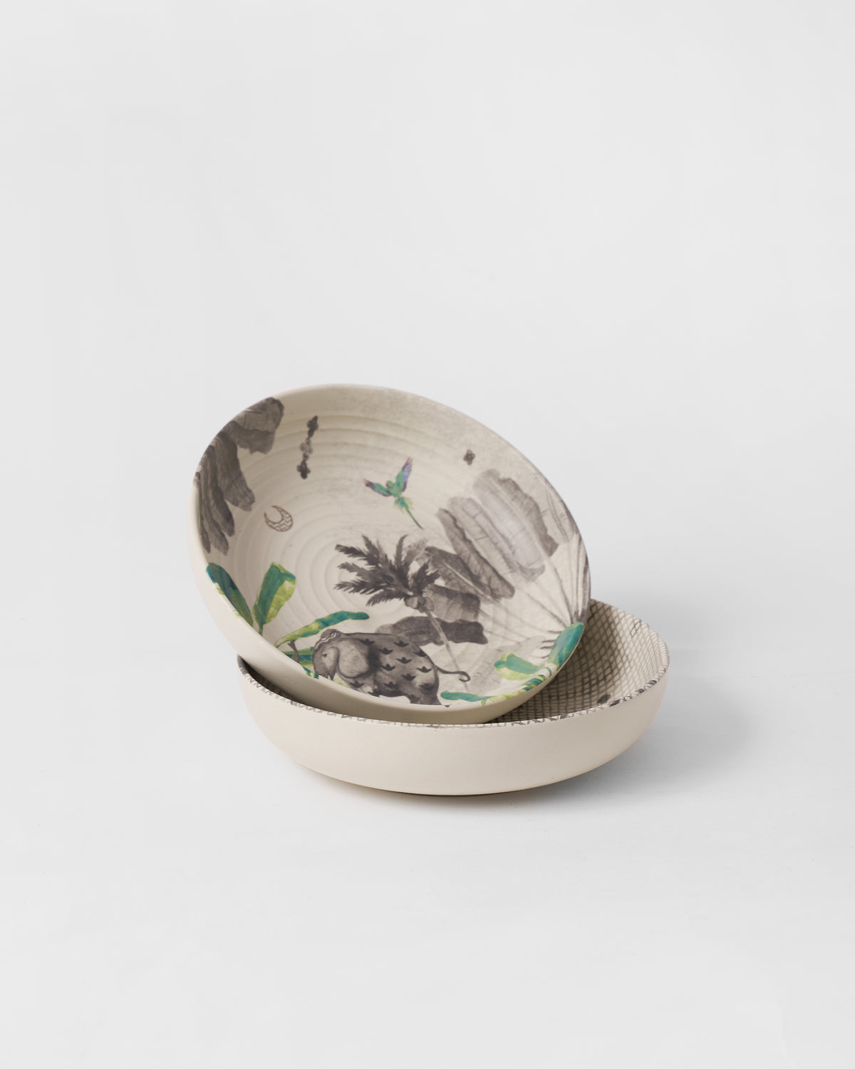 Stacked Haathi shallow bowls showing an elephant, palms, and green leaves inside.