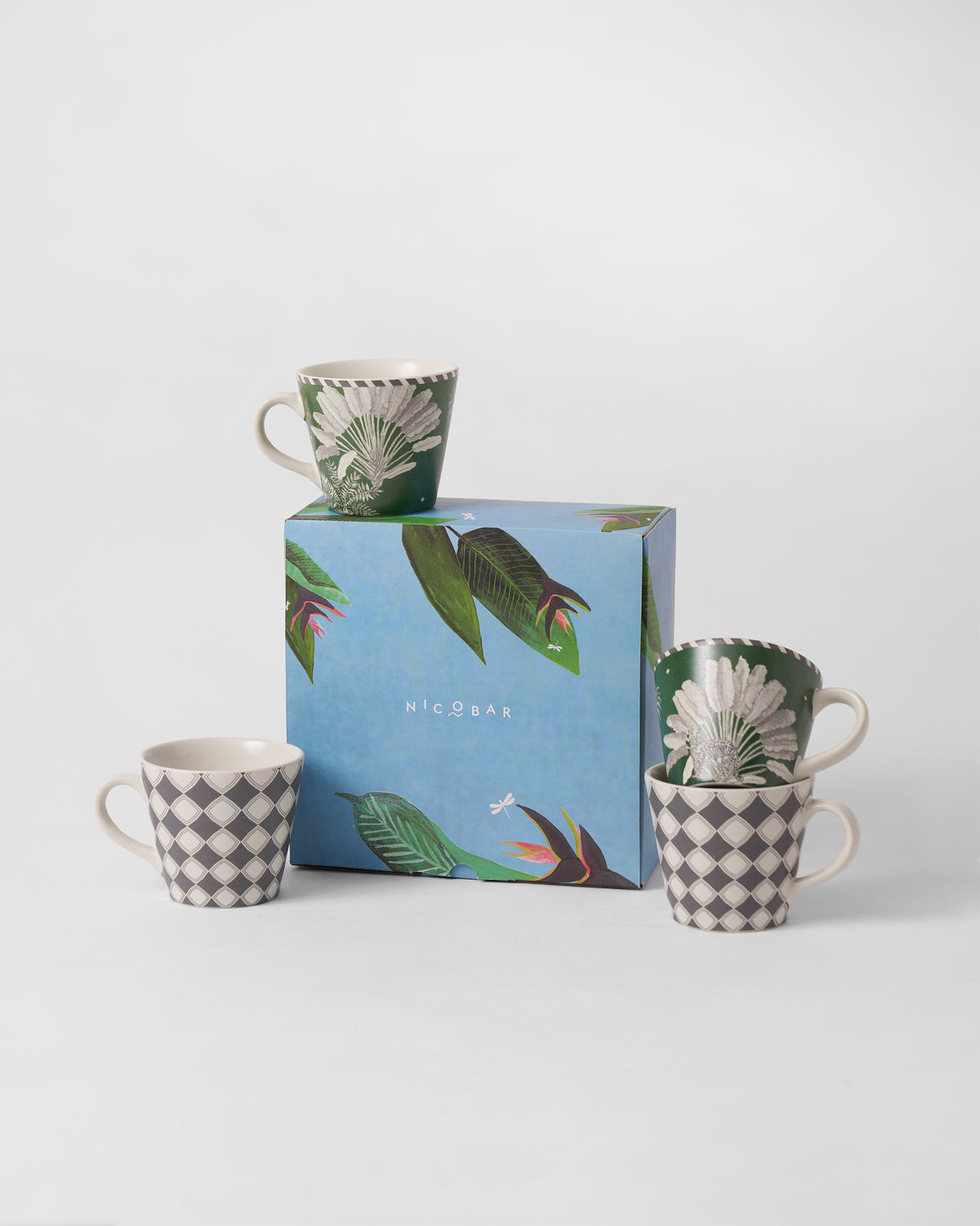 Kandy espresso mugs beside a blue tropical Nicobar gift box.