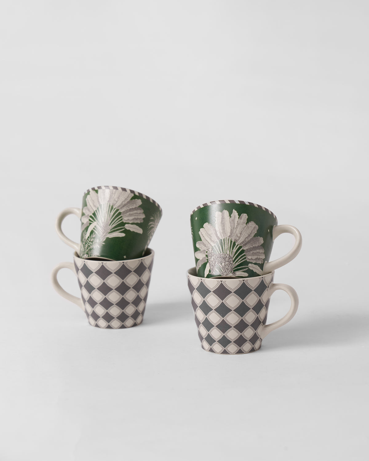 Stacked Kandy espresso mugs pairing green palm with diamond prints.