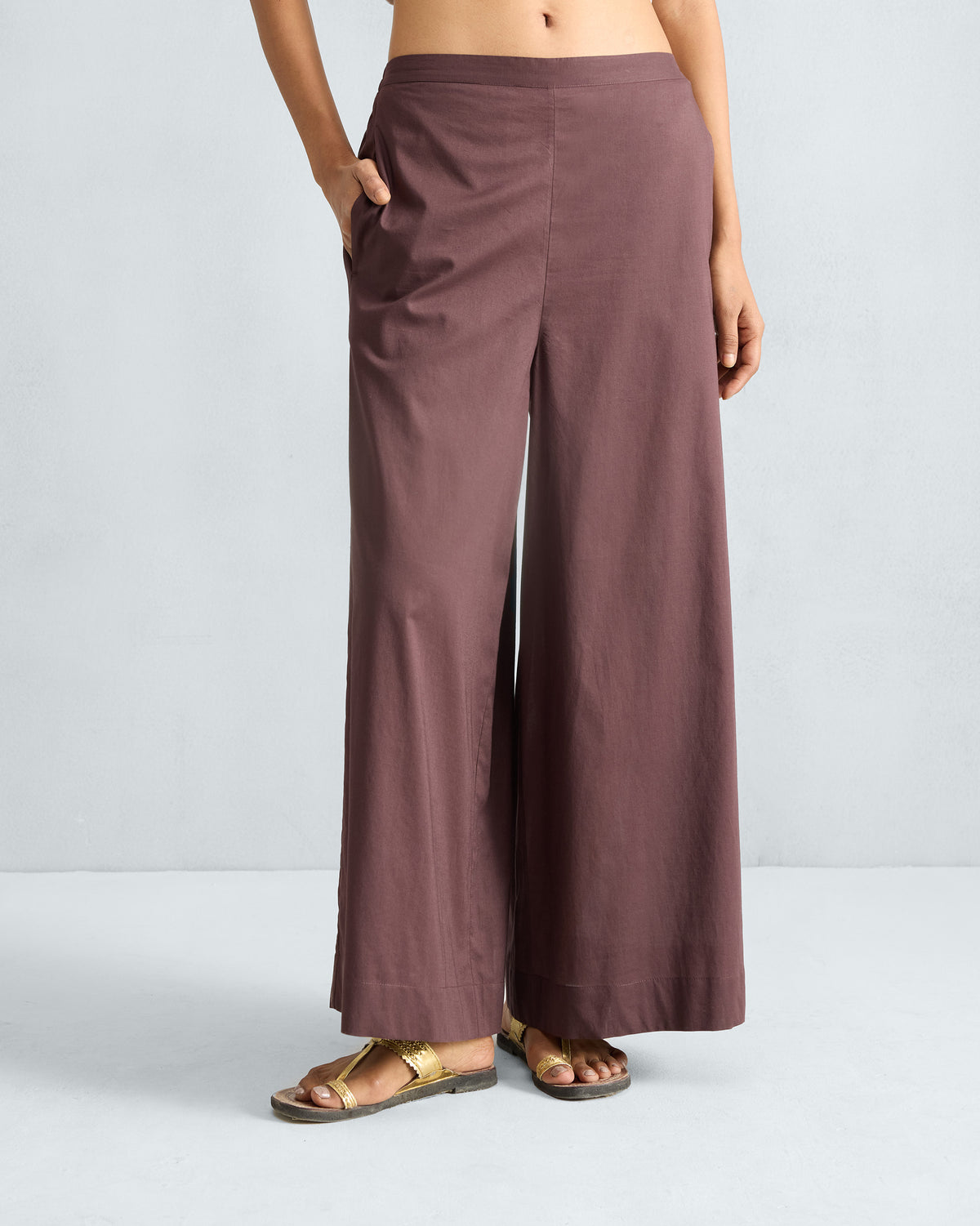 Person wearing chocolate plum Basic pyjamas with a wide A-line flare.
