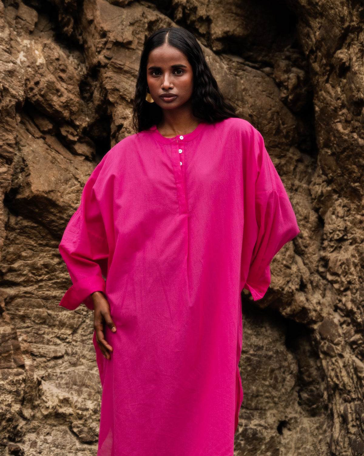 Person wearing a fuchsia Lazy Sunday tunic with batwing sleeves.