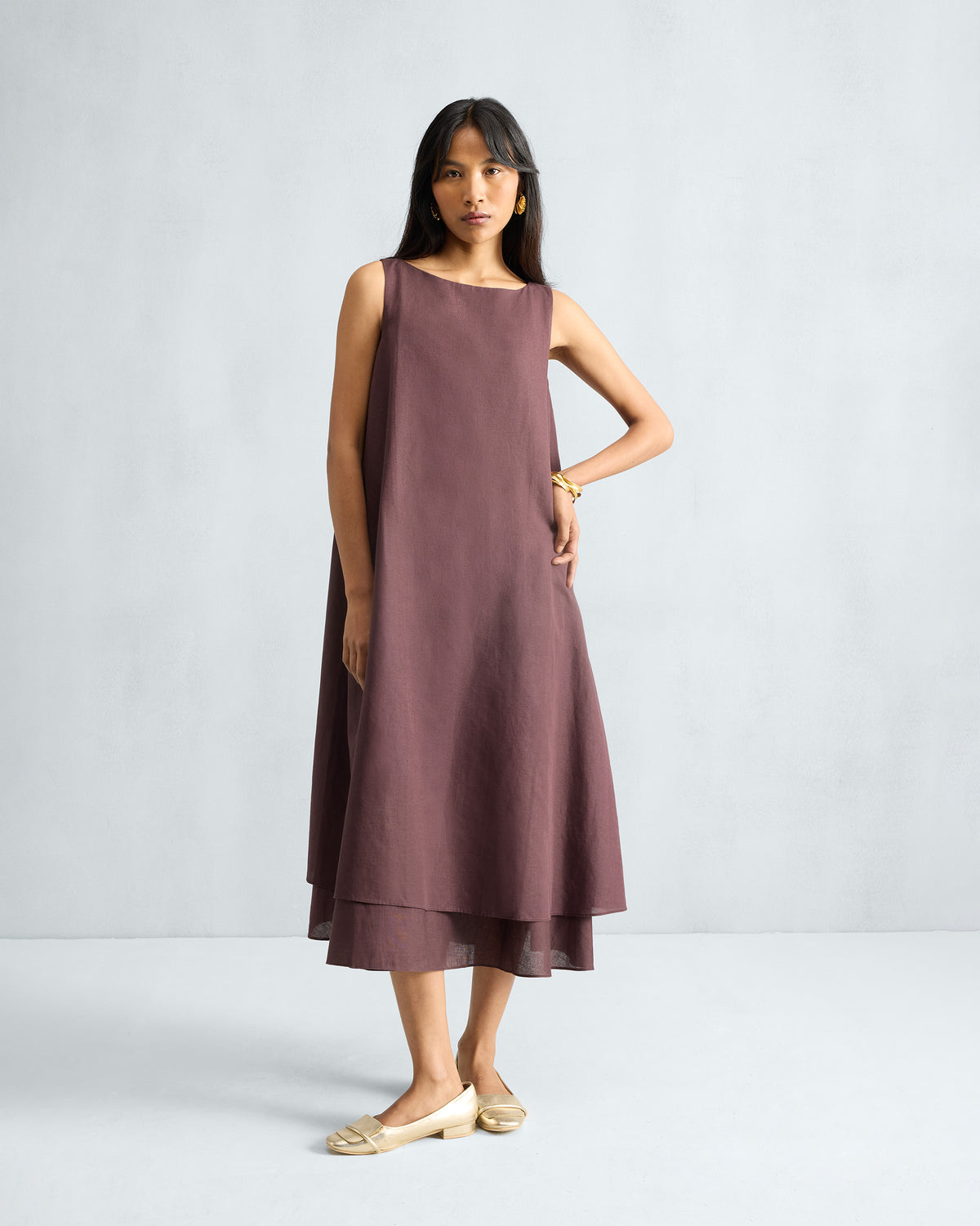 Person wearing a chocolate plum Double Layer Dress with a boat neck.