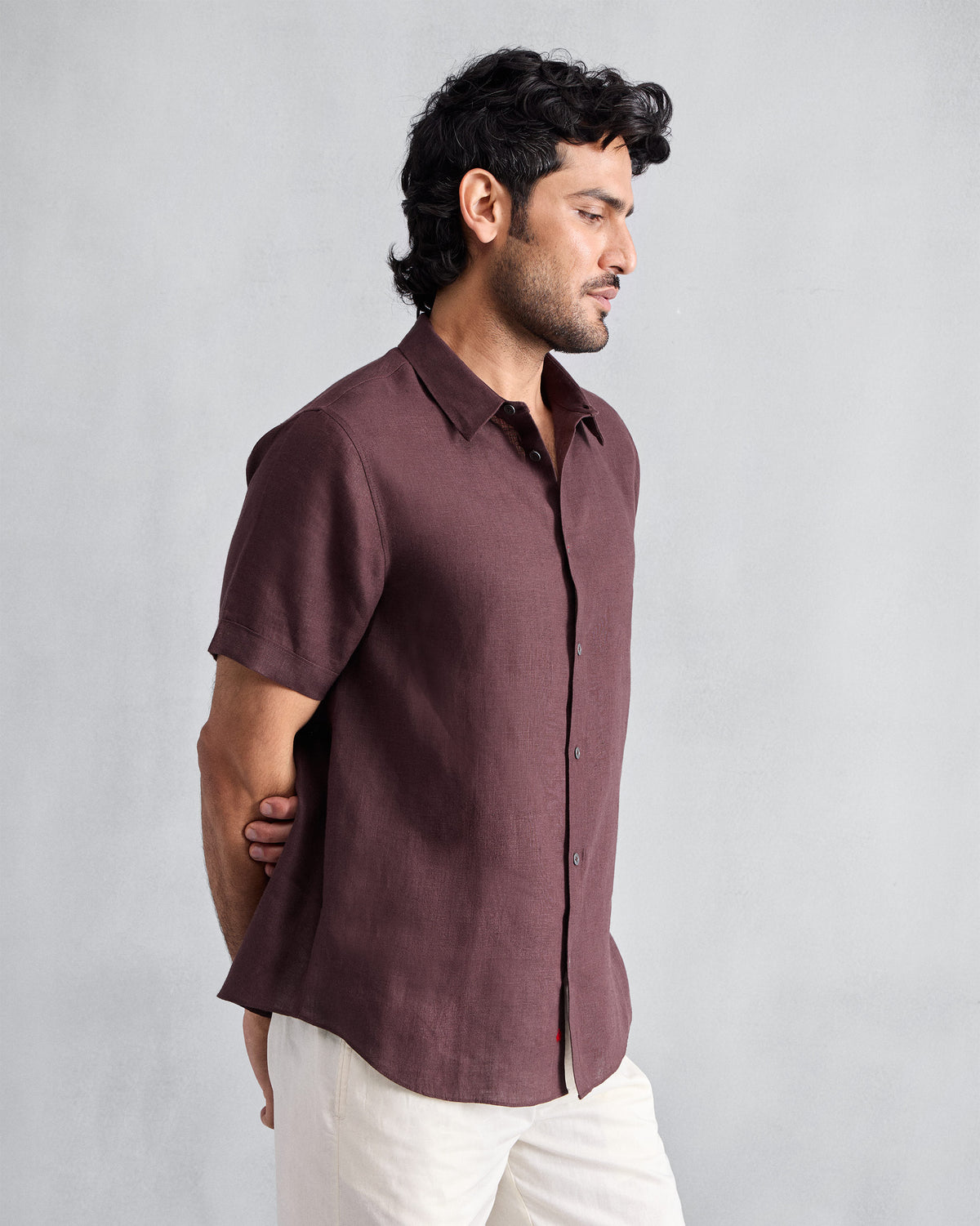 Side view of a chocolate plum half-sleeve shirt.