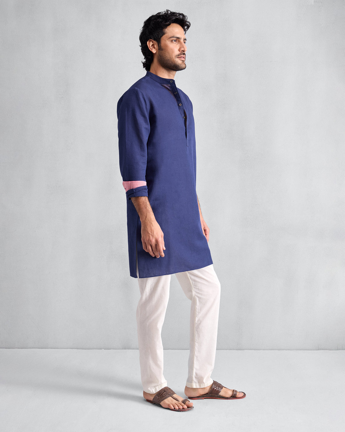 Side view of an ink blue Chandni Chowk Kurta showing mid-thigh length and pink cuff lining.