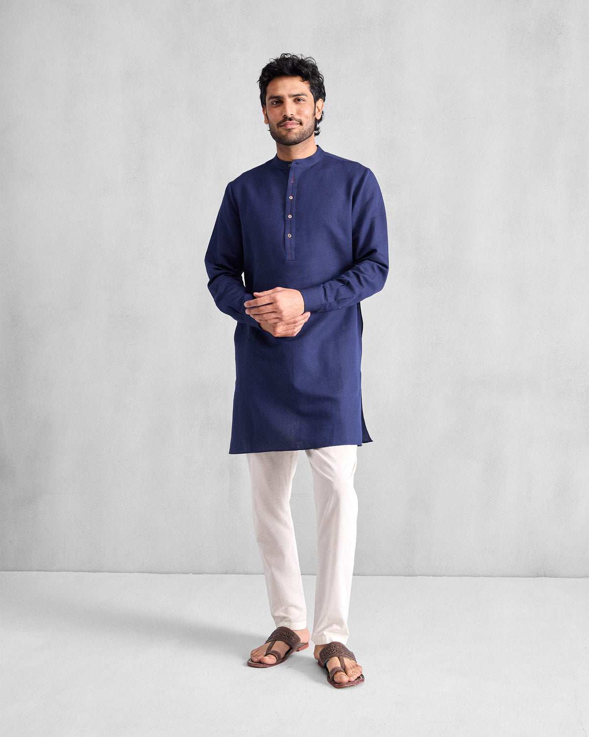 Person wearing an ink blue Chandni Chowk Kurta with a Nehru collar and short placket.