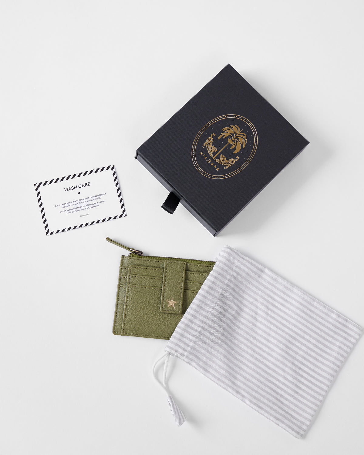 Green Everyday Star card holder shown with its gift box and dust bag.