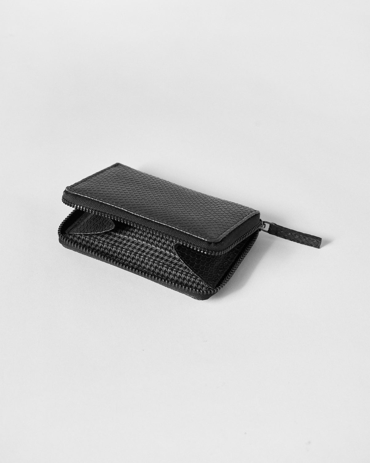 Open black All Rounder Wallet revealing a houndstooth lining.