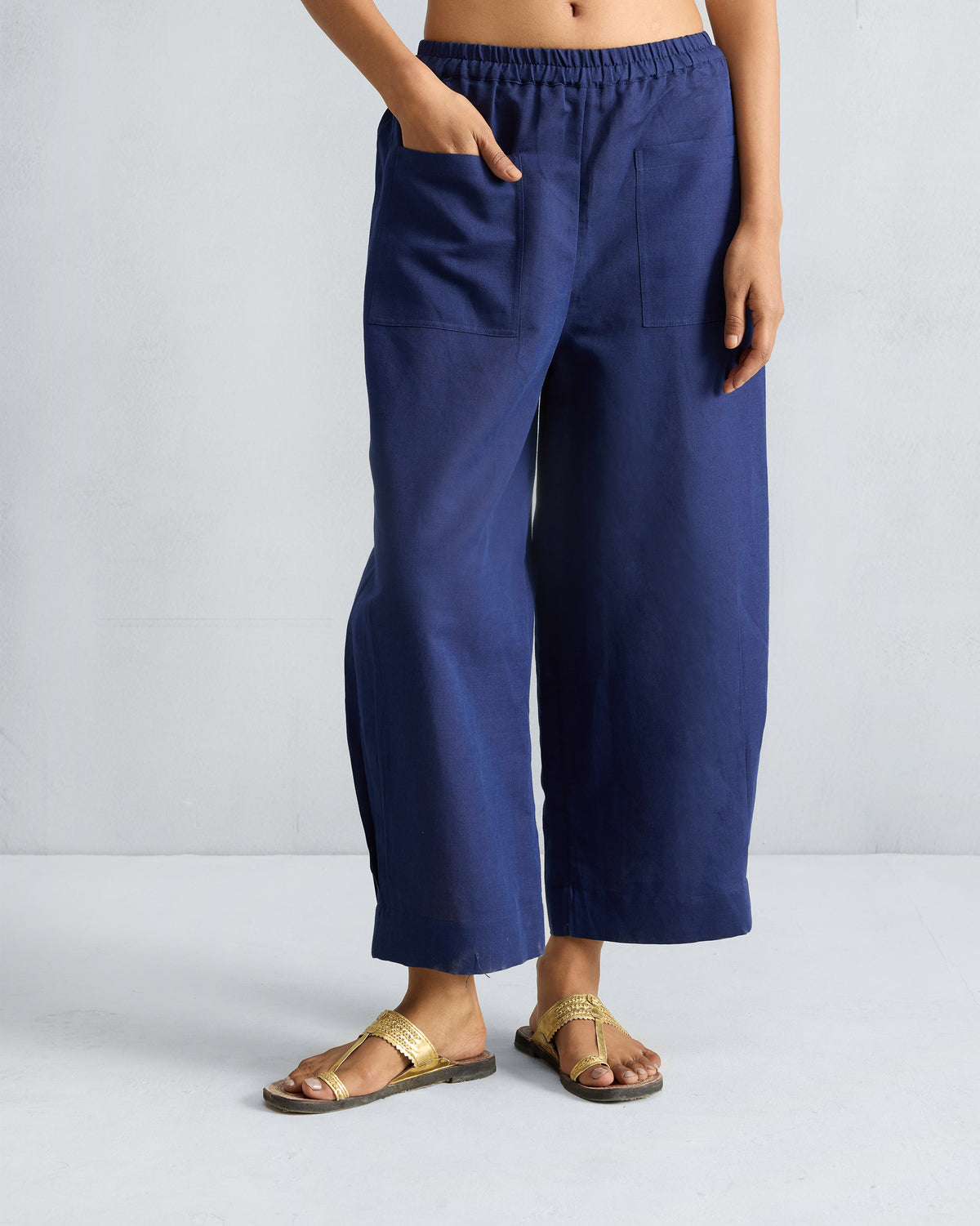 Person wearing ink blue Serene pants with large front patch pockets.