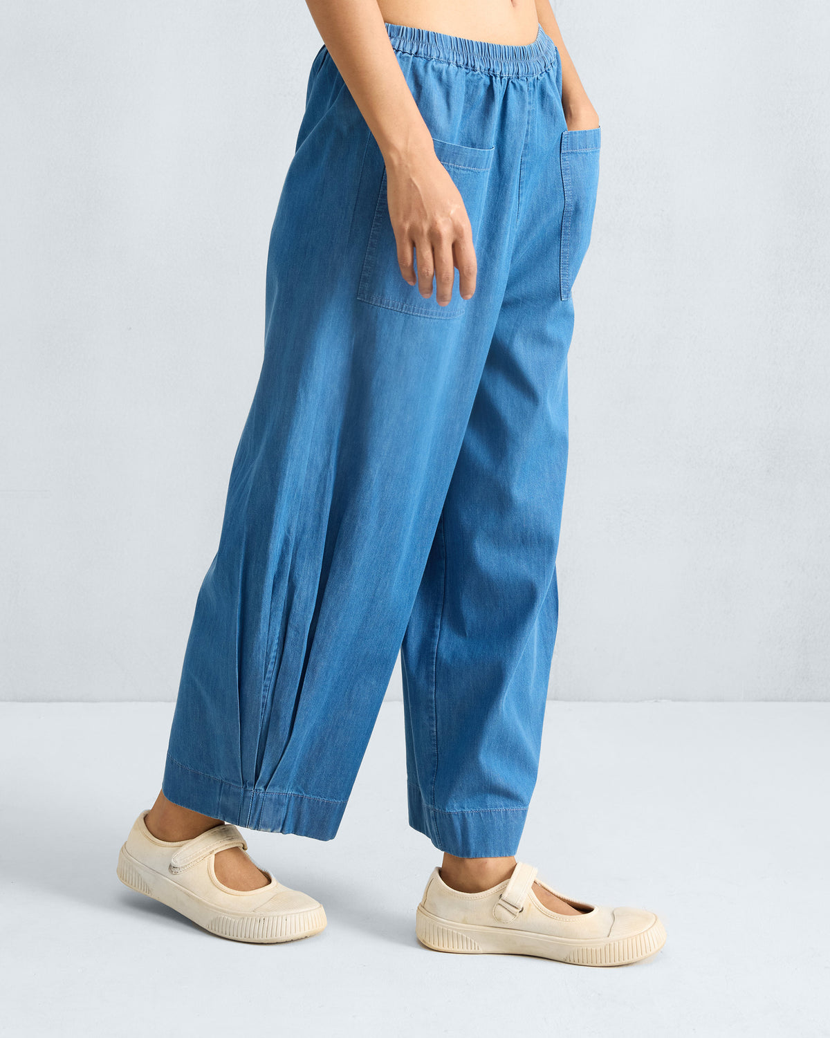 Side view of denim Serene pants with a wide cropped leg.