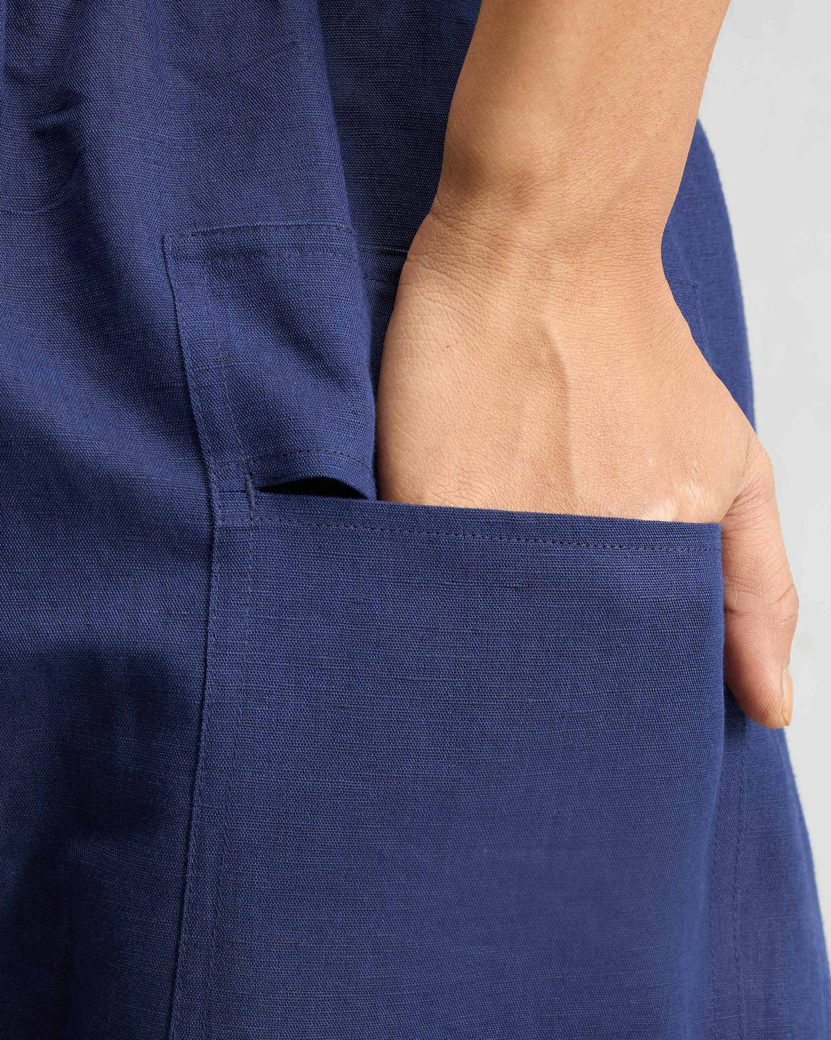 Close-up of a deep pocket on ink blue Yoka Trousers.