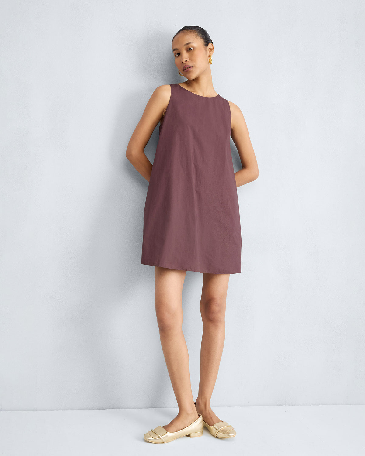 Person wearing a chocolate plum short racerback dress.