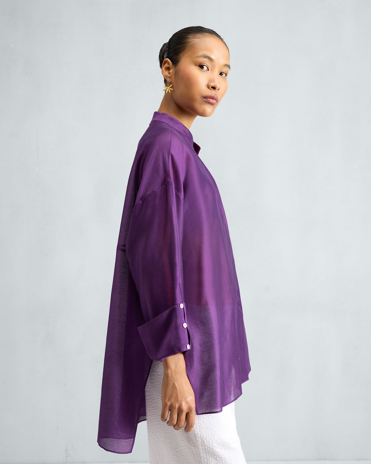 Side view of a purple Cirrus shirt showing the side slit and wide cuff.