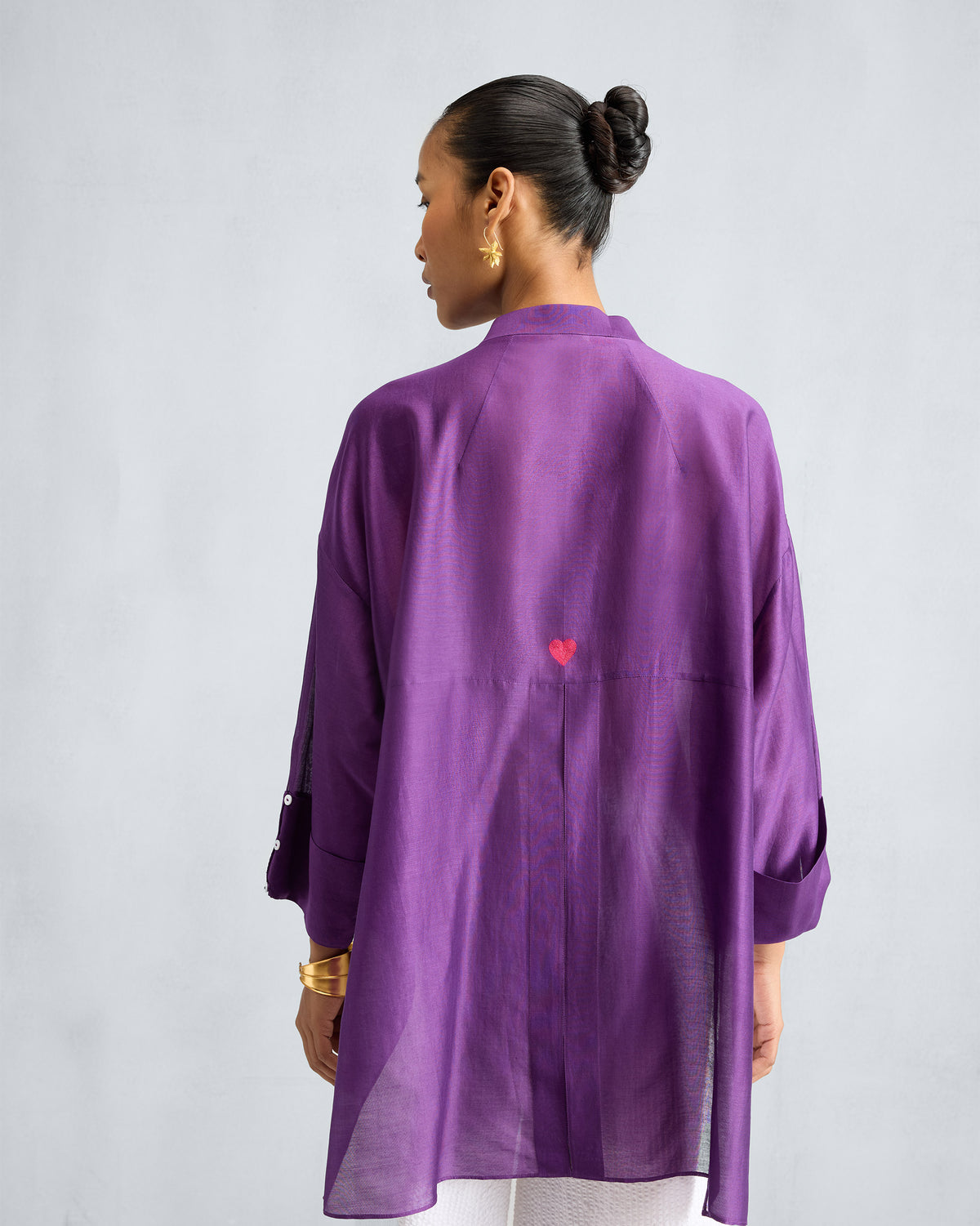 Back of a purple Cirrus shirt with a small red embroidered heart.