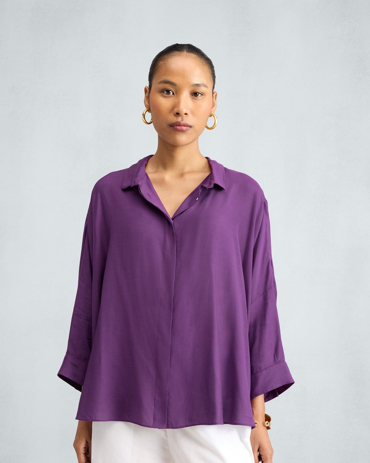 Person wearing a purple Boxy shirt with a concealed button placket.