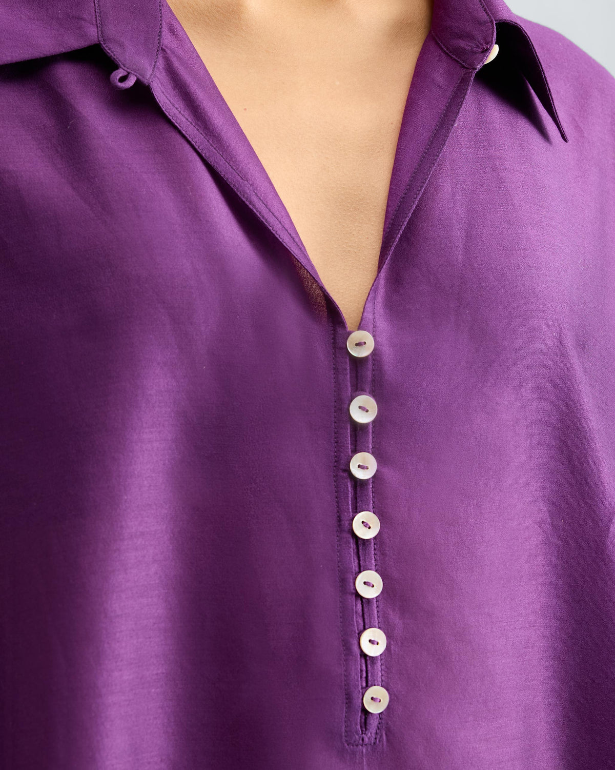 Close-up of the Hala Tunic V-placket showing its small buttons.