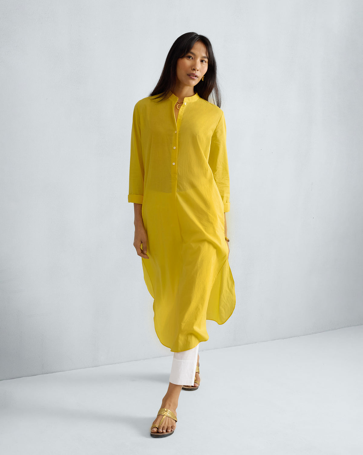 Person wearing a yellow Basic Long Kurta with a band collar and side slits.