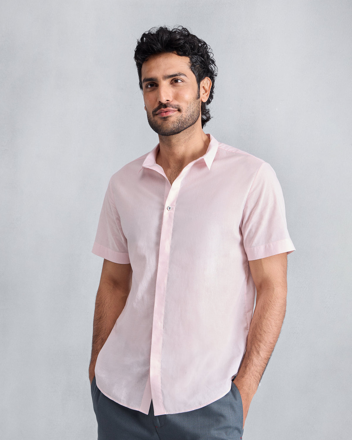 Person wearing a pink short-sleeve Riverine Shirt.