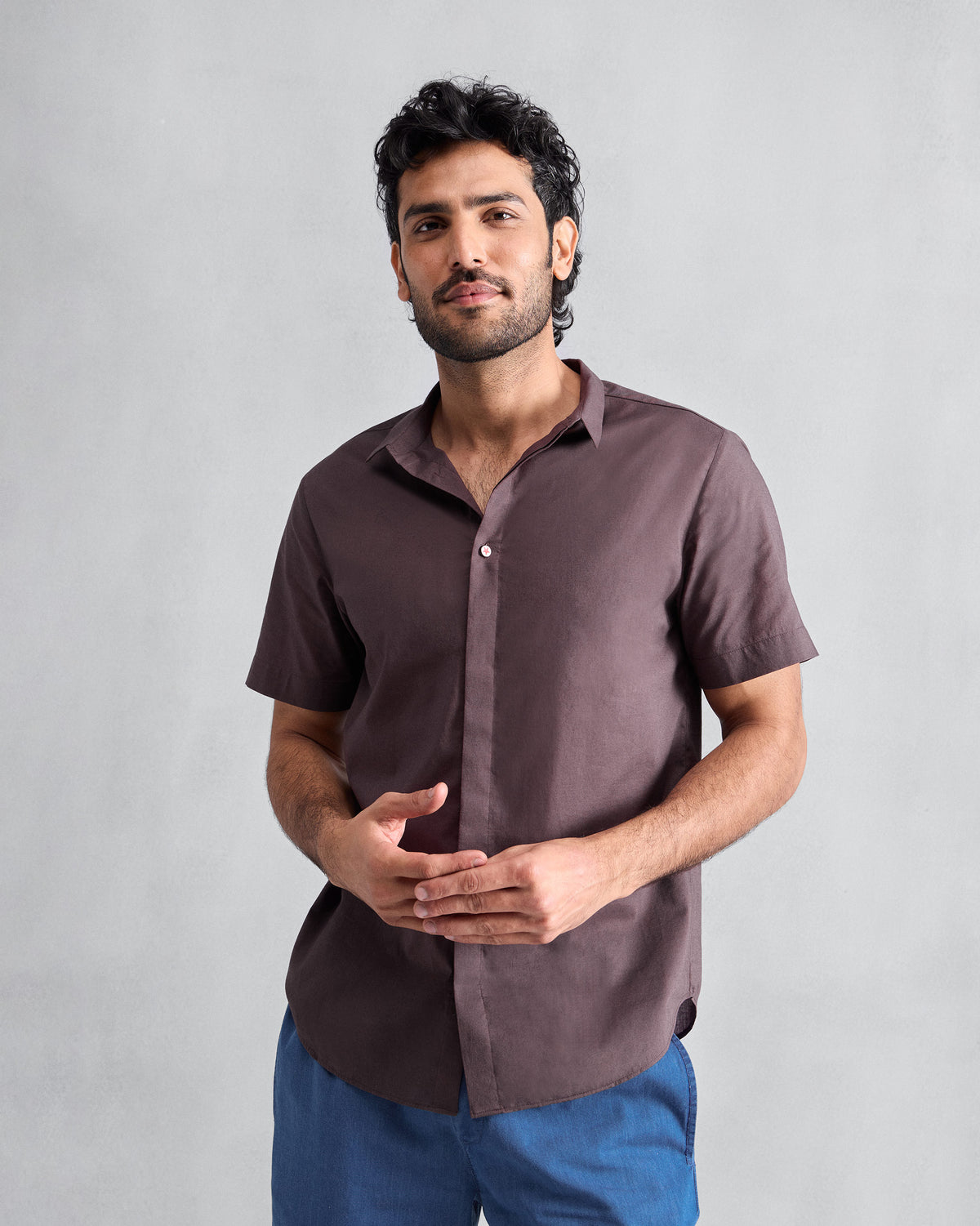 Person wearing a chocolate plum Riverine short-sleeve shirt.