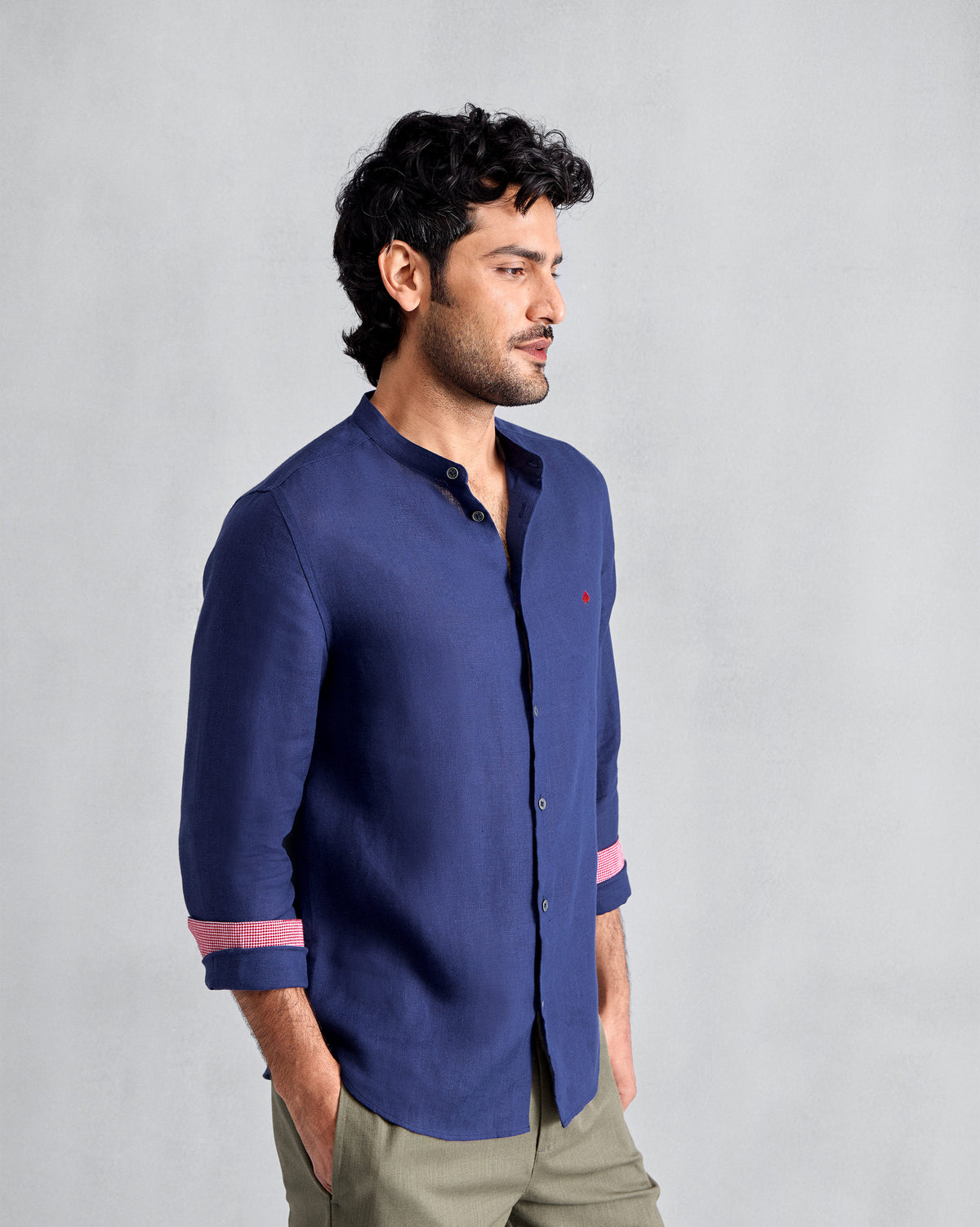 Side view of an ink blue Nawab shirt with pink cuff lining.