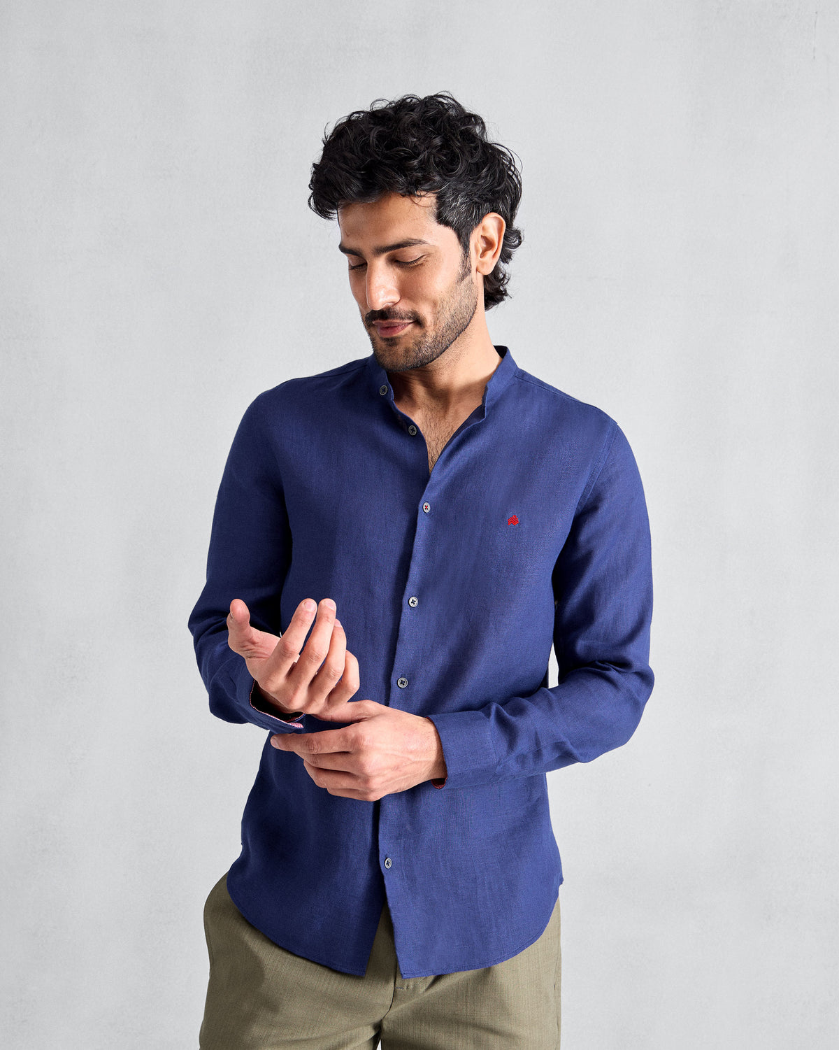 Person wearing an ink blue Nawab shirt with a band collar.