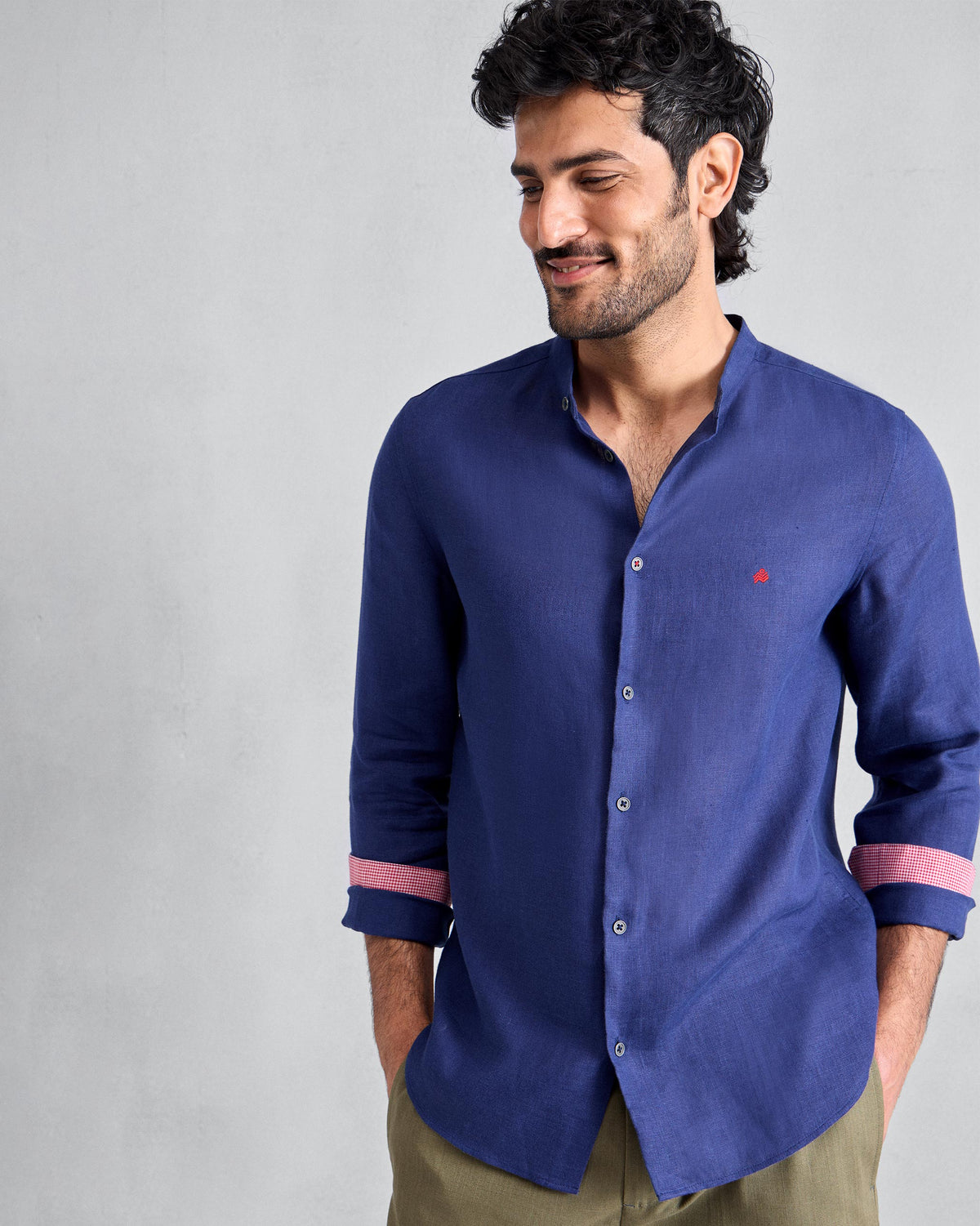 Person wearing an ink blue Nawab shirt with pink cuff lining.