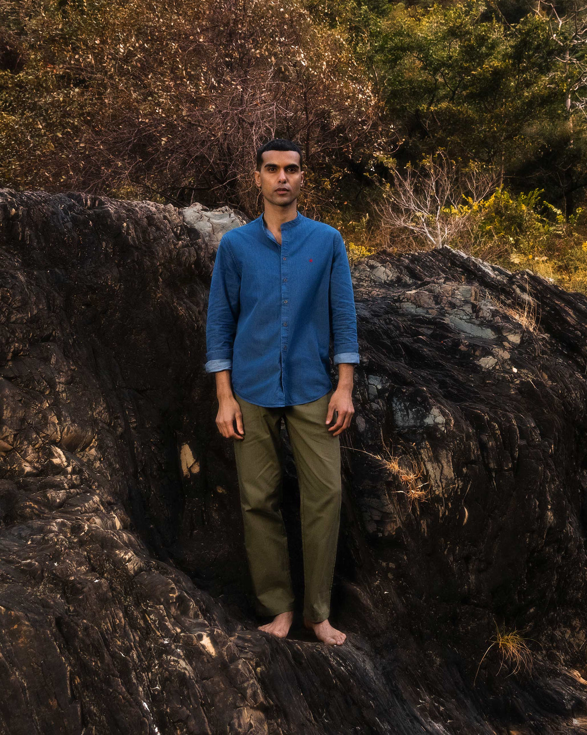 Person wearing a denim Nawab Shirt with a Nehru collar and rolled sleeves.