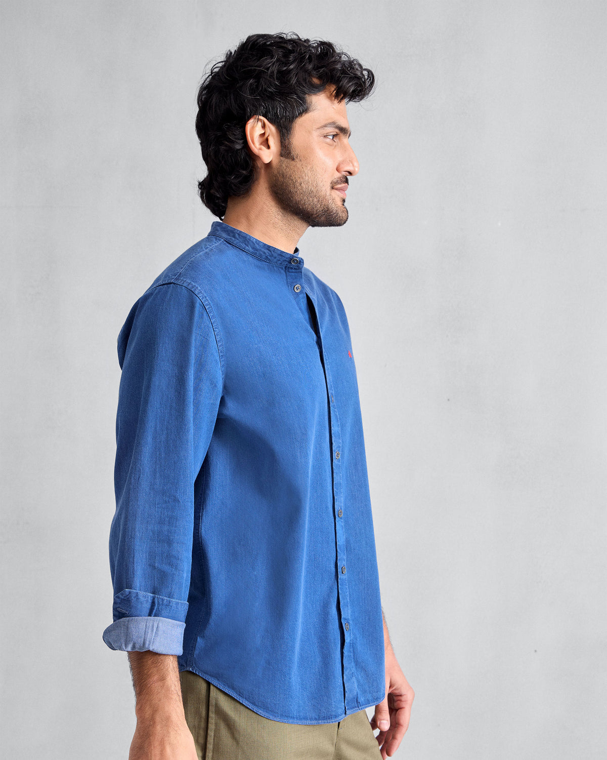 Side view of a denim Nawab Shirt with a Nehru collar and rolled cuff.