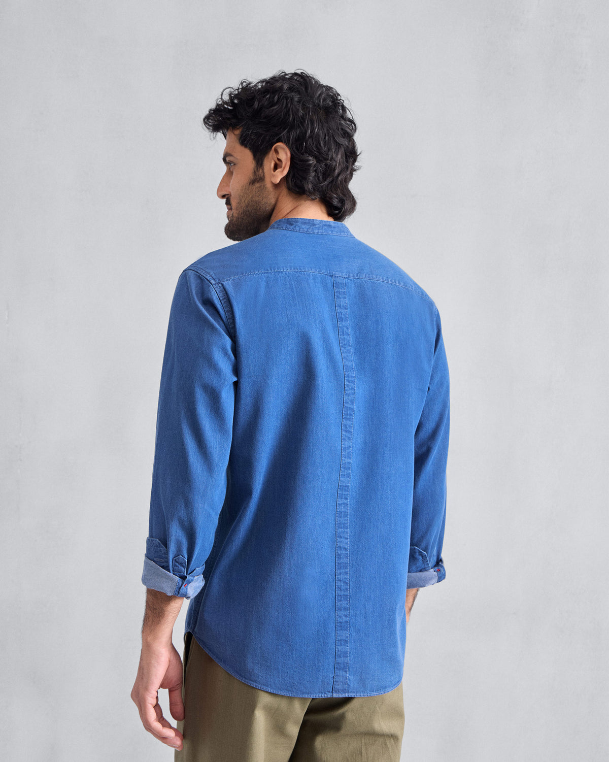 Back of a denim Nawab Shirt with a Nehru collar and centre back seam.