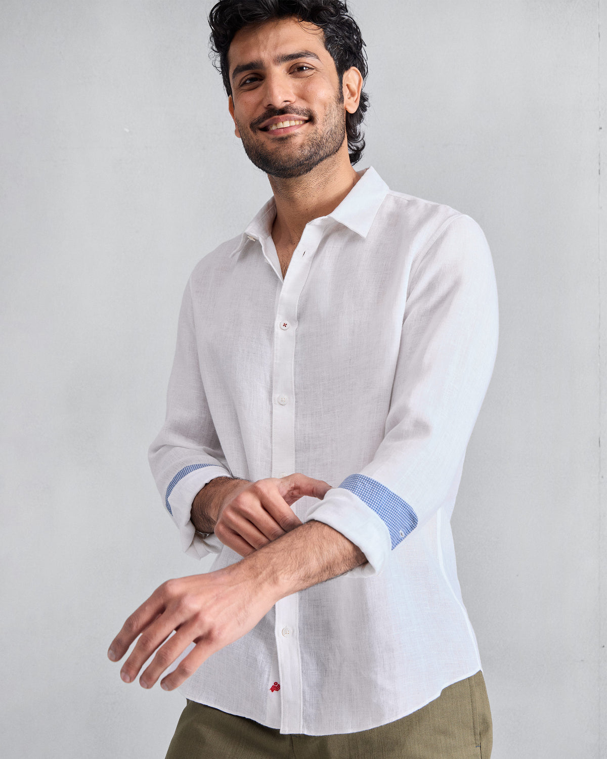 Person wearing a white Classic shirt with blue cuff lining.