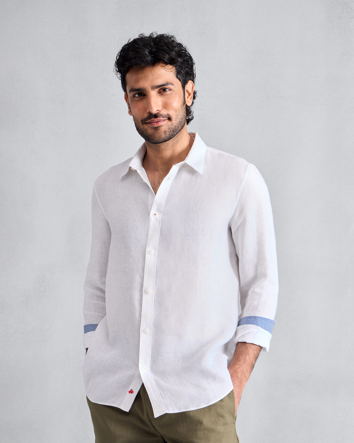 Person wearing a white Classic shirt with blue cuff lining.