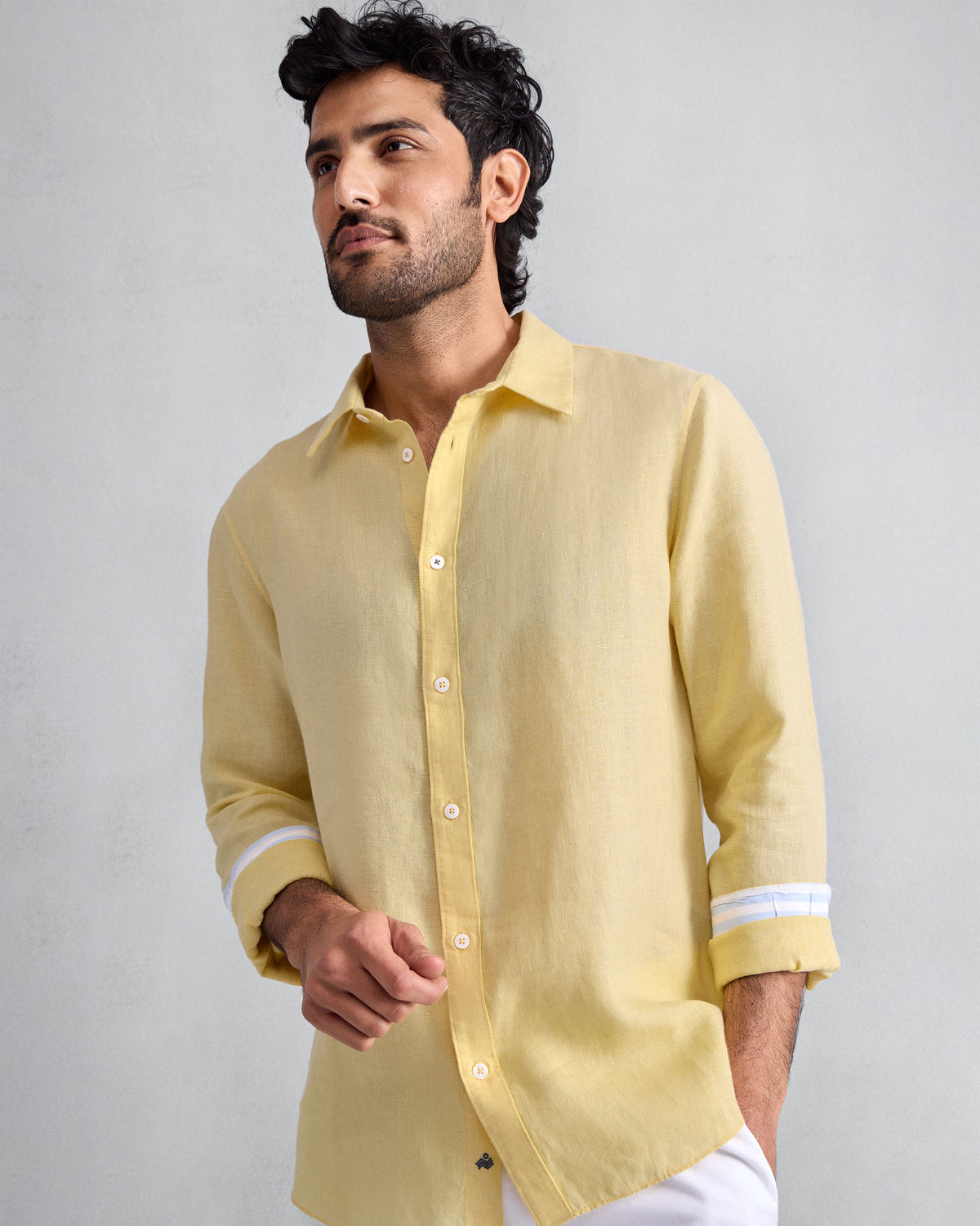 Person wearing a lemon Classic shirt with rolled sleeves.