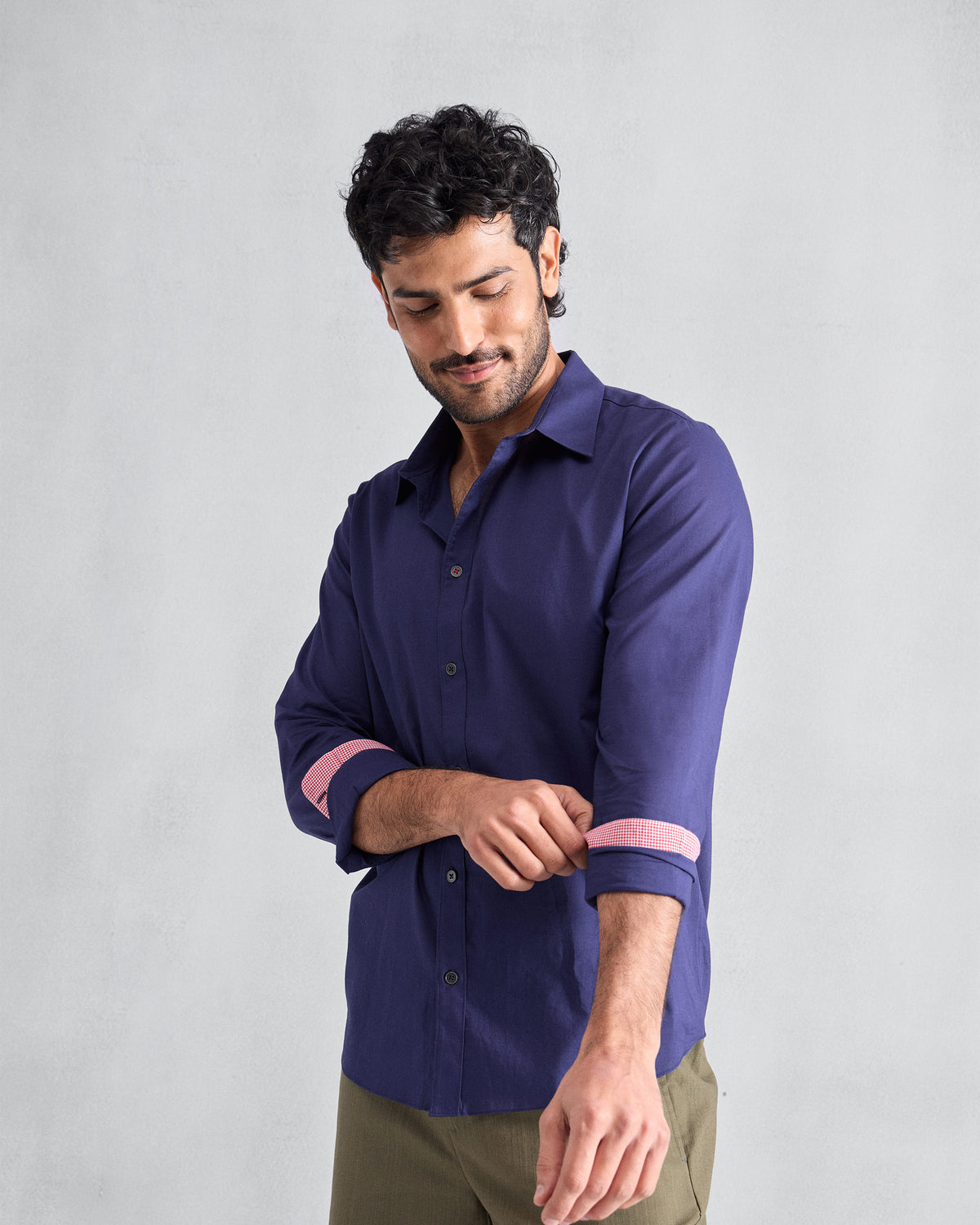 Person wearing an ink blue Classic shirt with pink cuff lining.