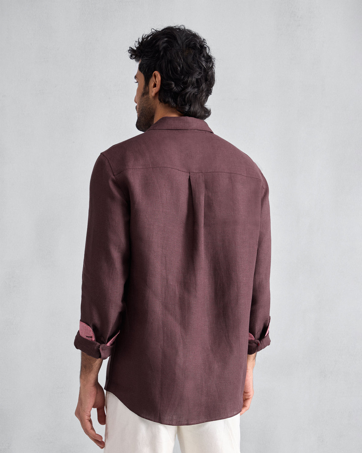 Back of a chocolate plum Classic shirt with a box pleat.