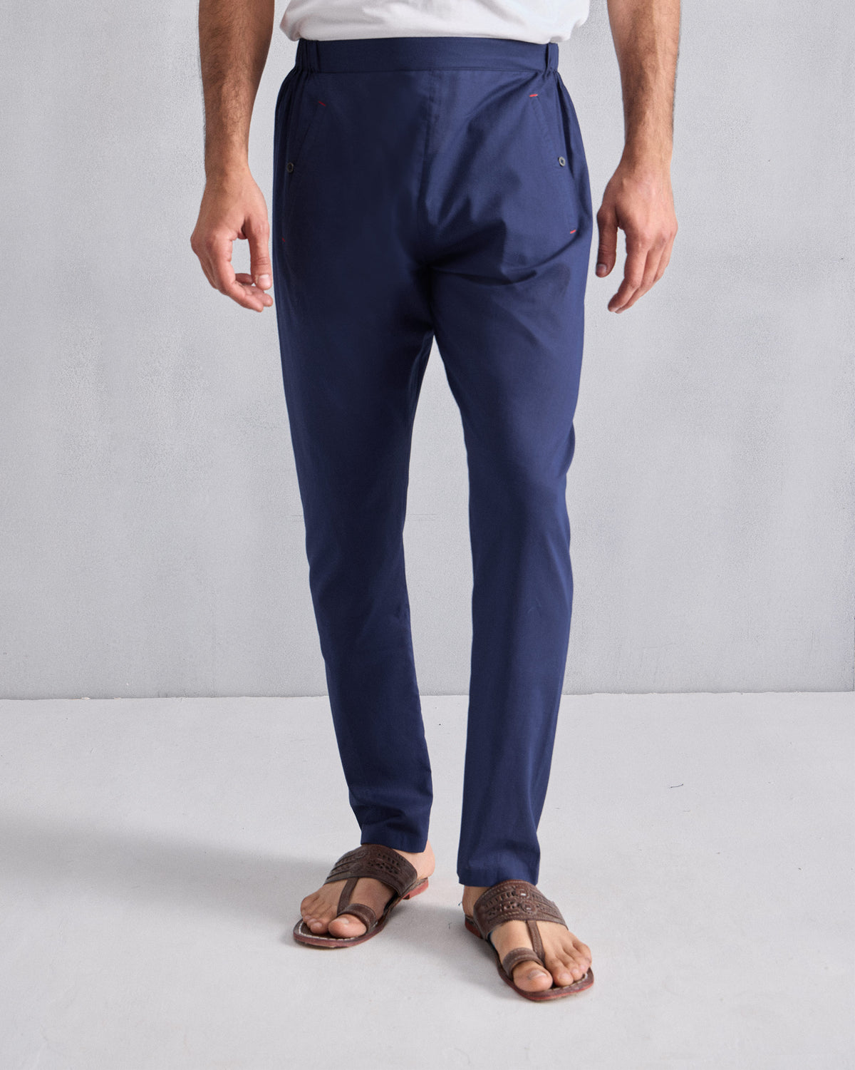 Person wearing ink blue Kurta Pants with a flat front.