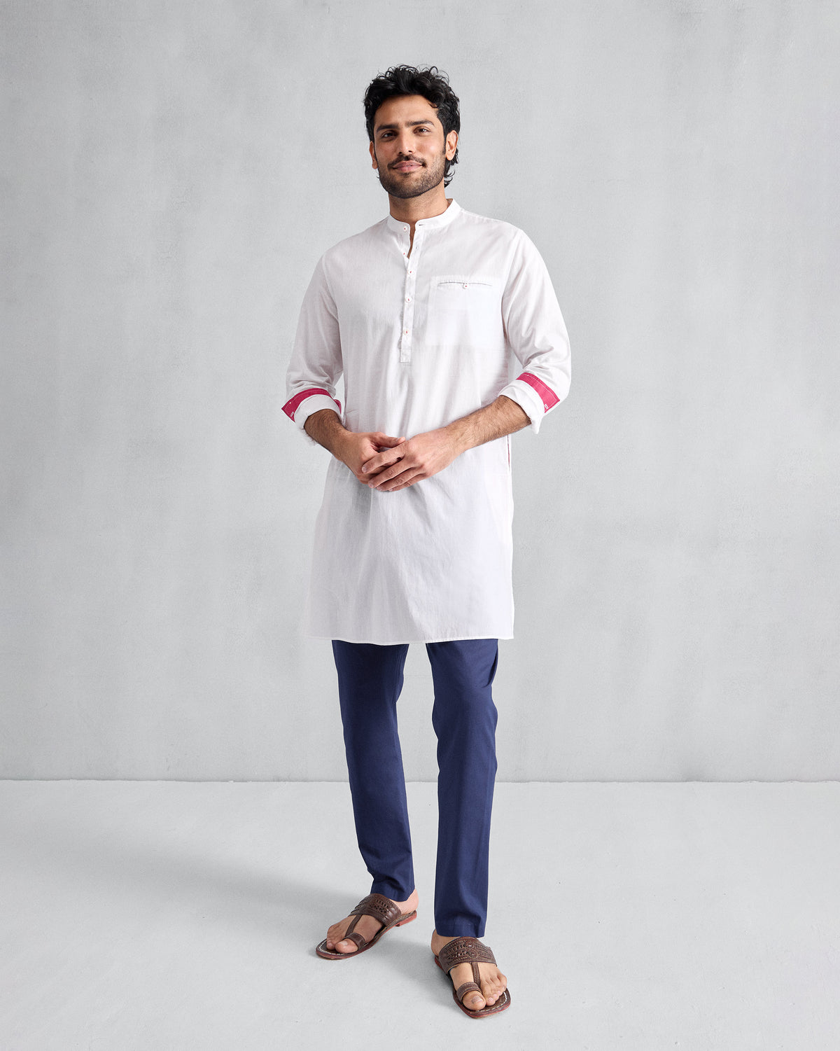 Person wearing ink blue Kurta Pants styled with a white kurta.
