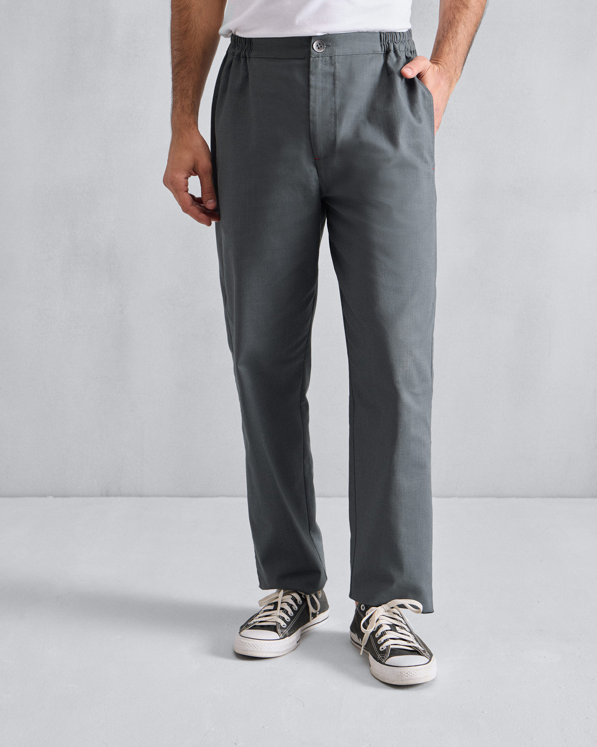Person wearing grey Meadow Pants with an elasticated waist.