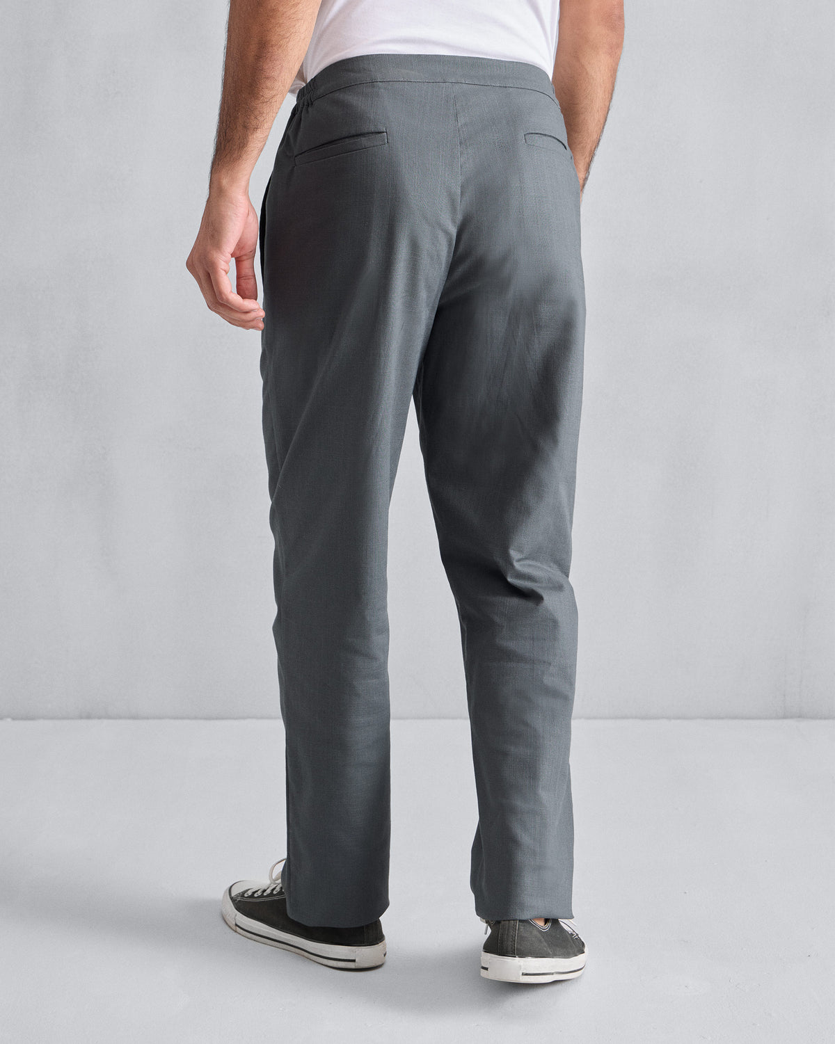 Back of grey Meadow Pants worn by a person.